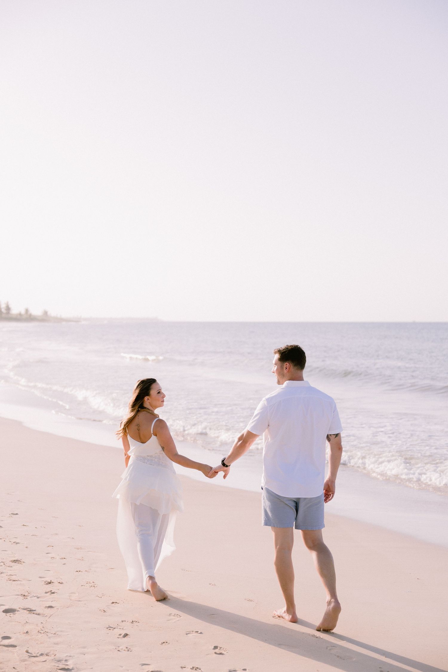 Punta Cana anniversary photographer capturing couple walking barefoot on the beach