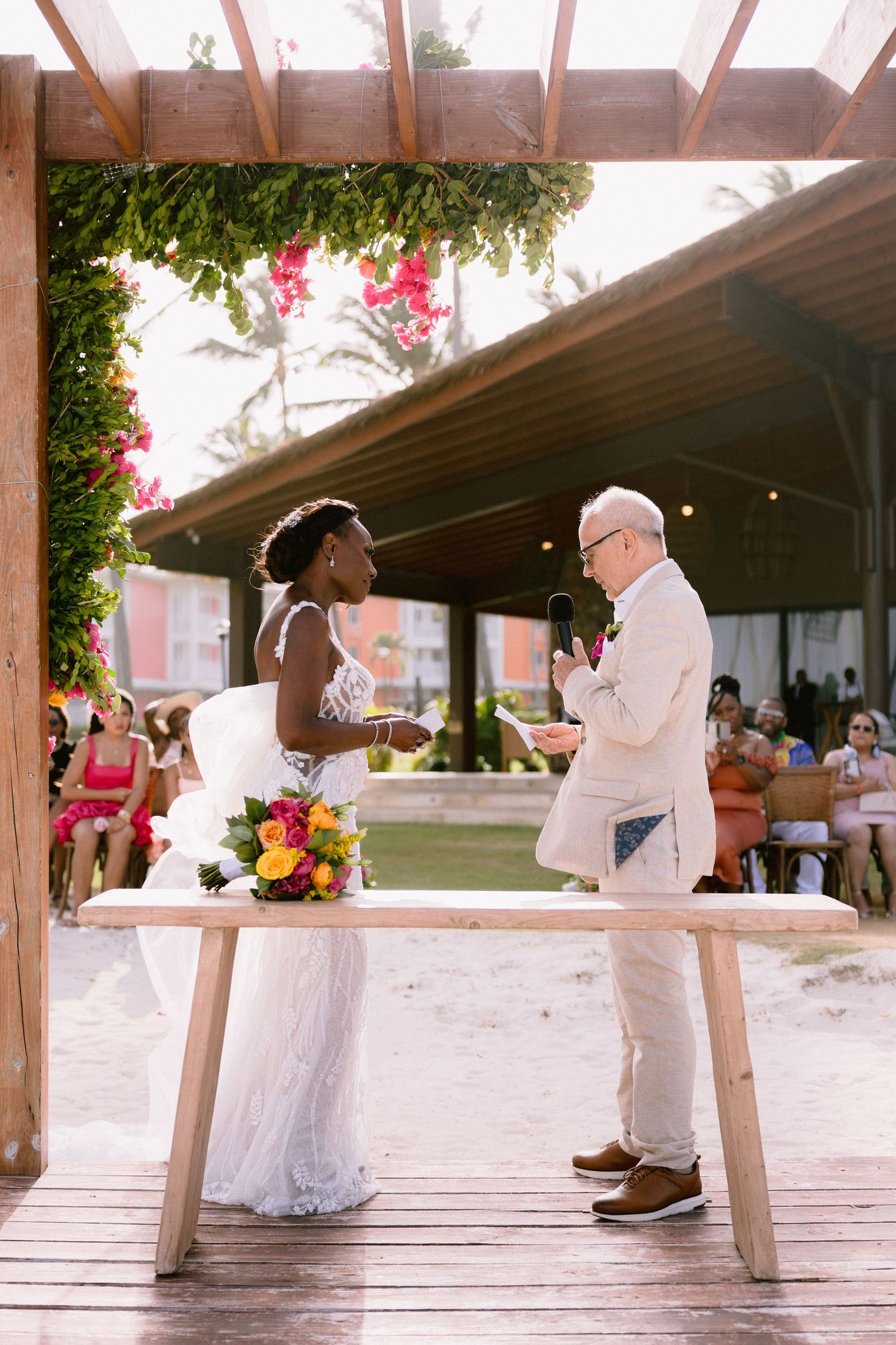 A series of wedding photos showing couples dancing on a wooden deck with pink flowers and greenery in the background.