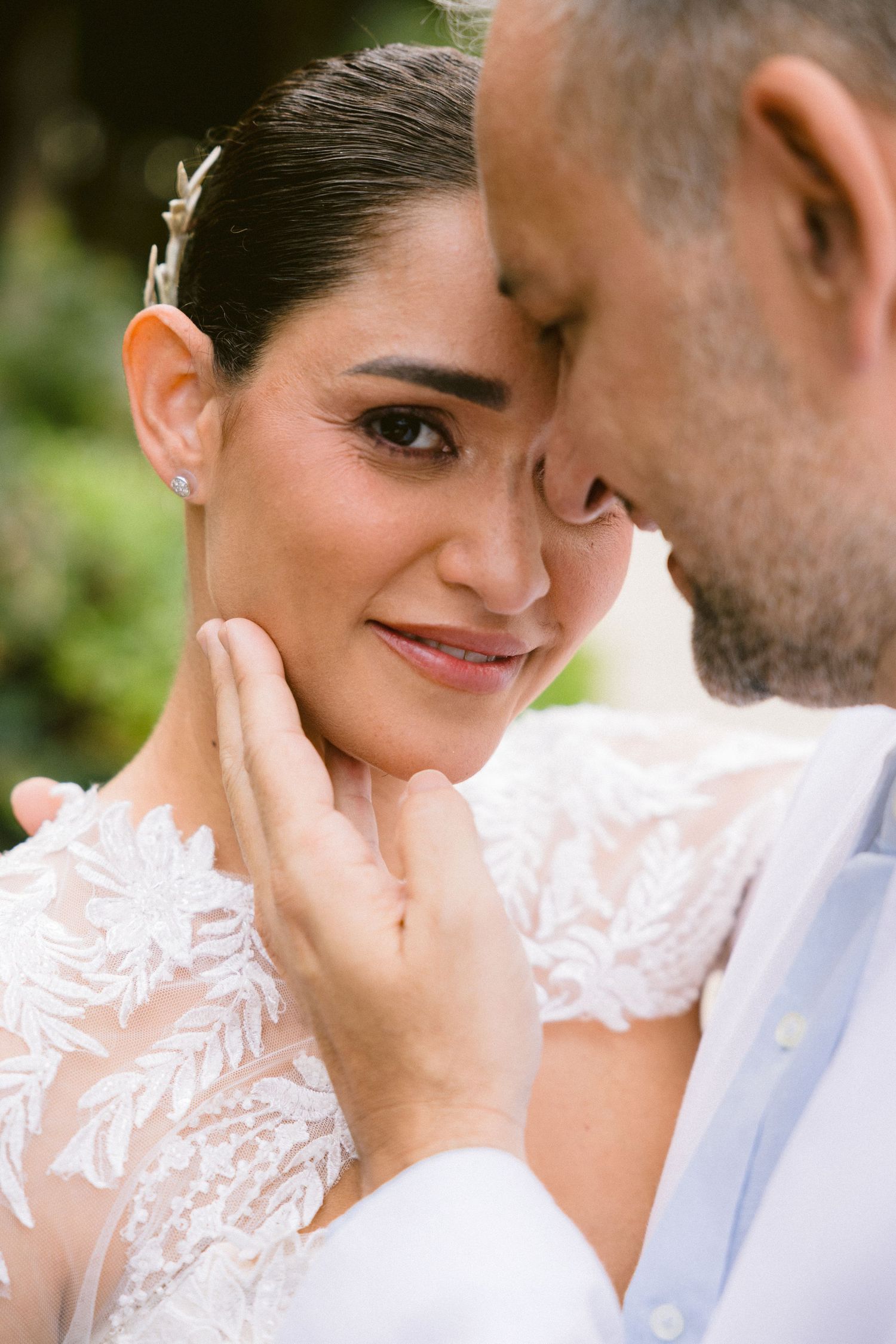 A romantic wedding photo sequence showing tender moments between a couple in white attire against a natural backdrop.
