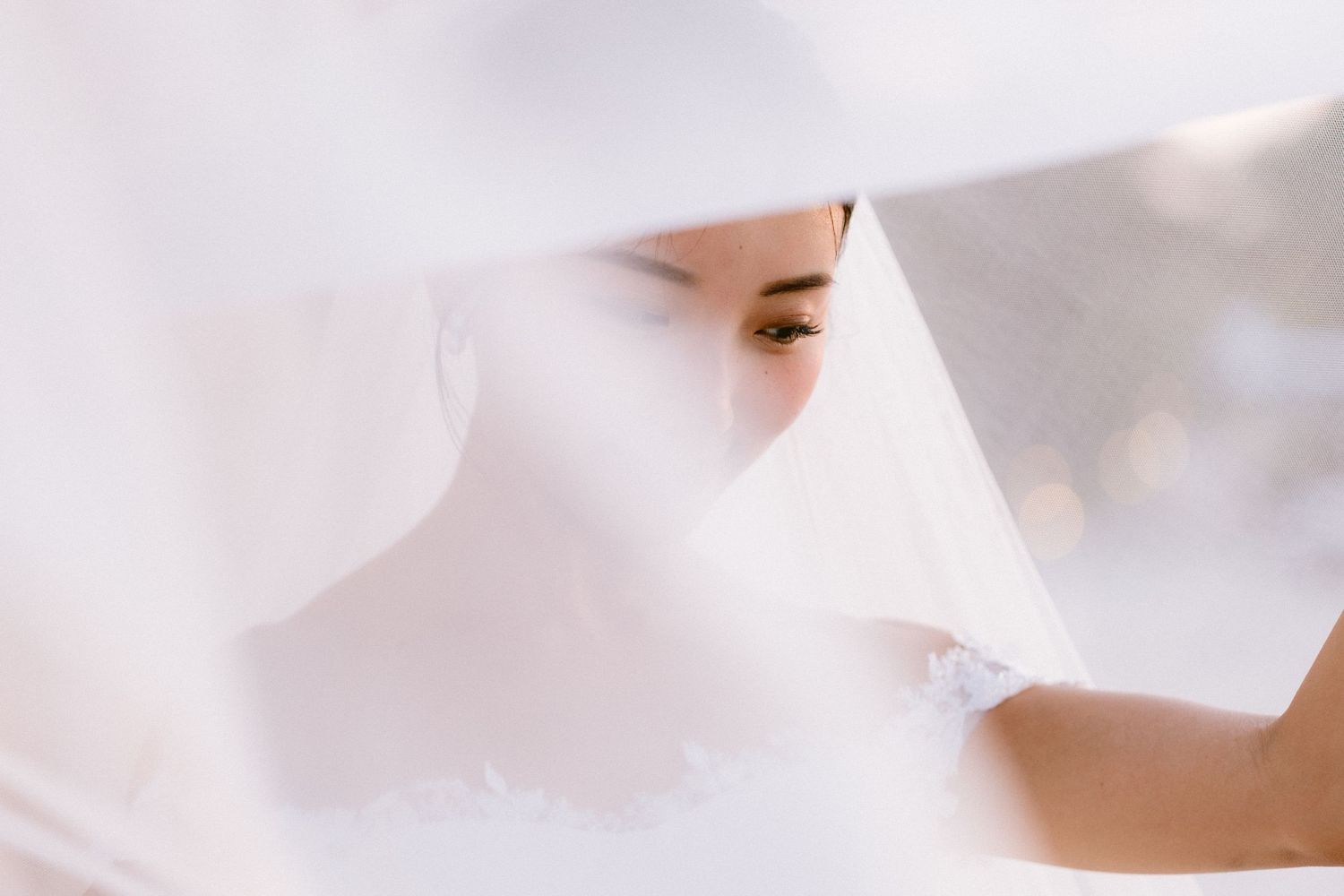 A close-up view of white delicate fabric or tulle material creating a soft, ethereal texture.