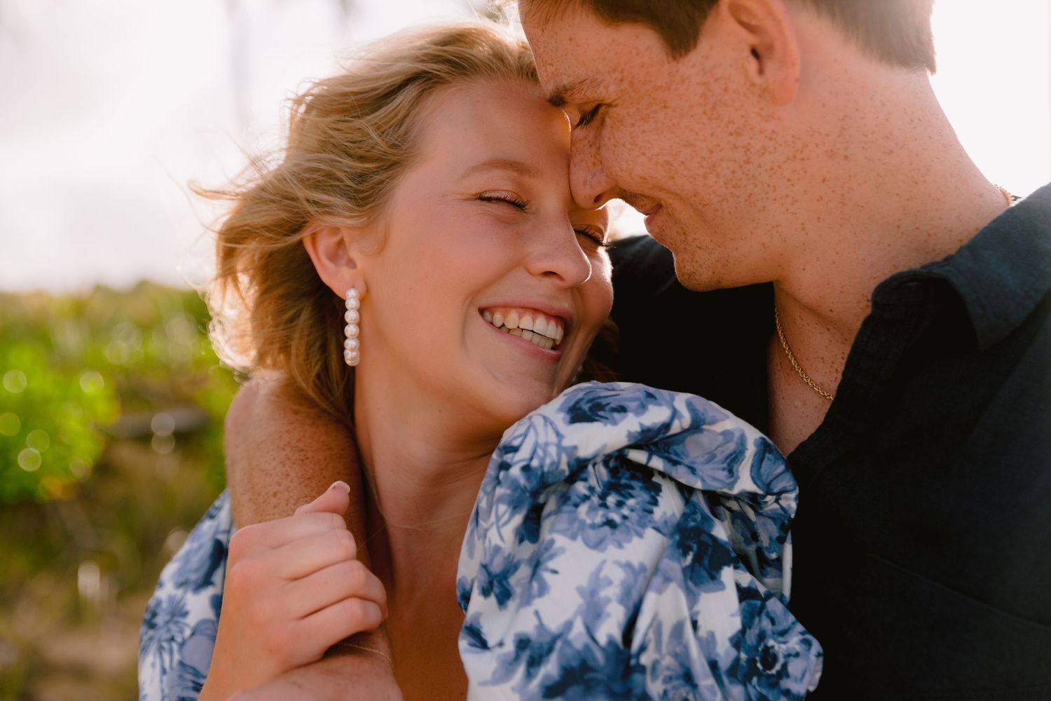 Intimate portrait of couple sharing tender moment during sunset.