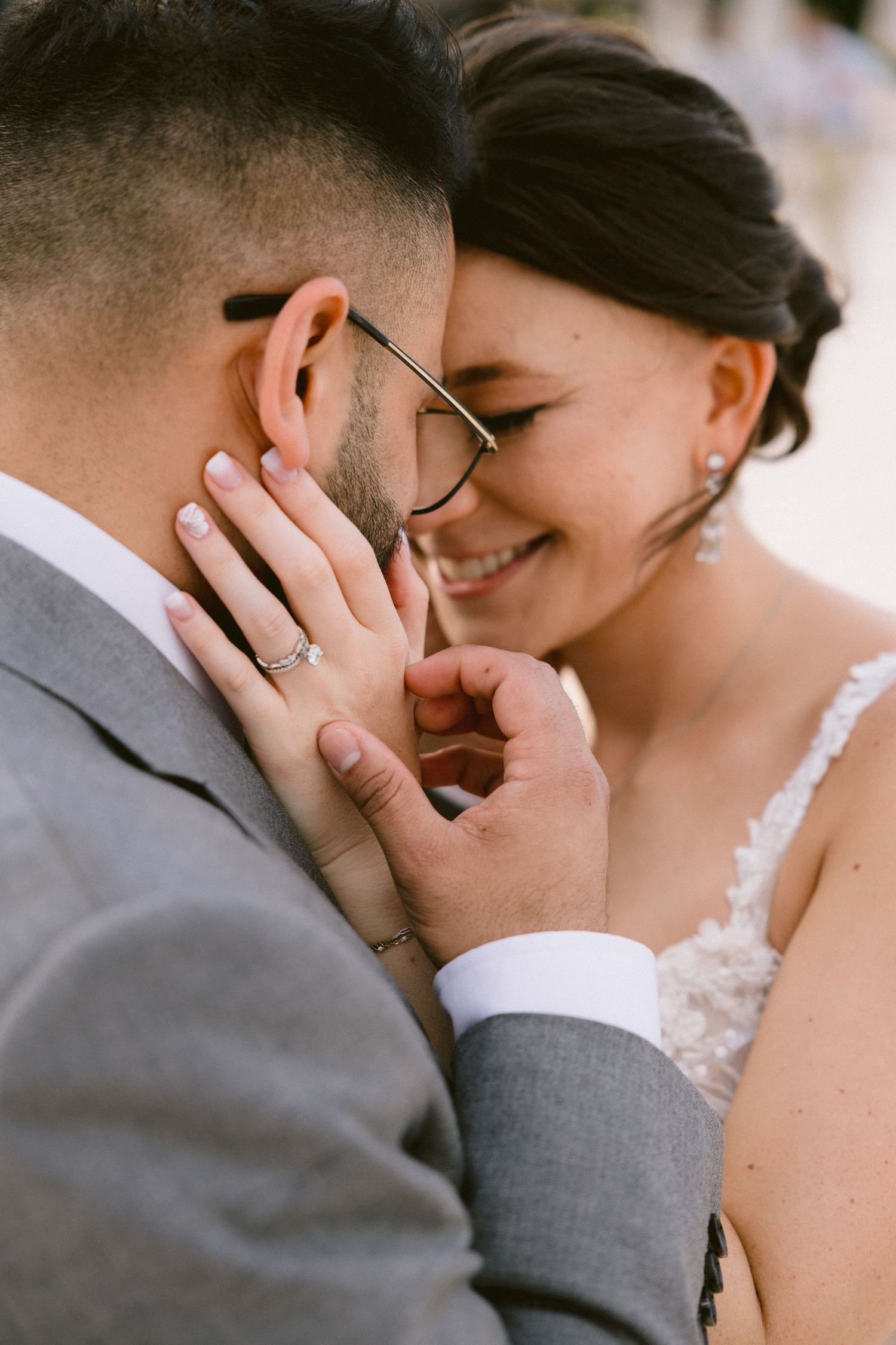 Close-up romantic moment captured between couple wearing formal attire.