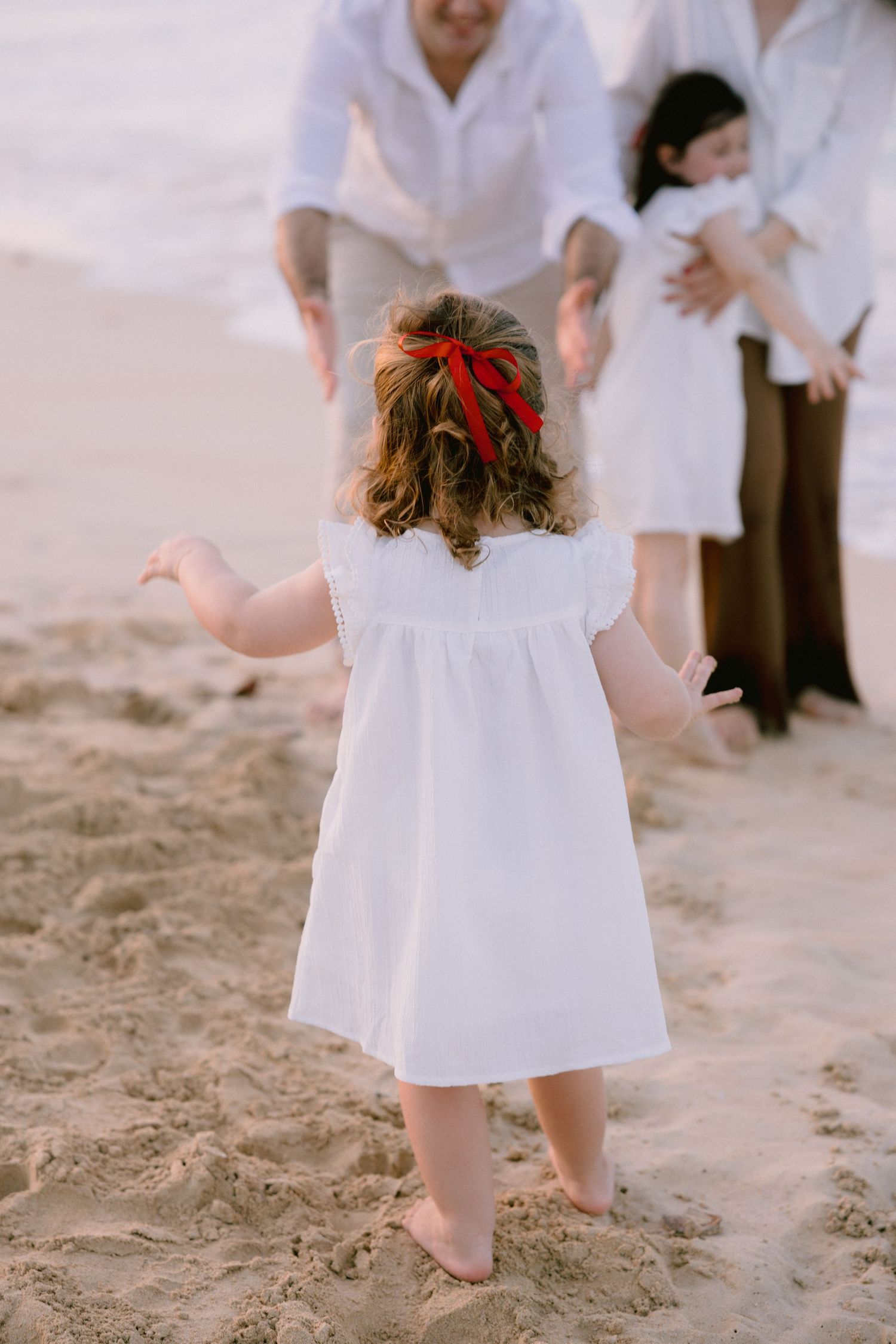 A series of photos showing someone in a white dress walking barefoot on sandy beach.