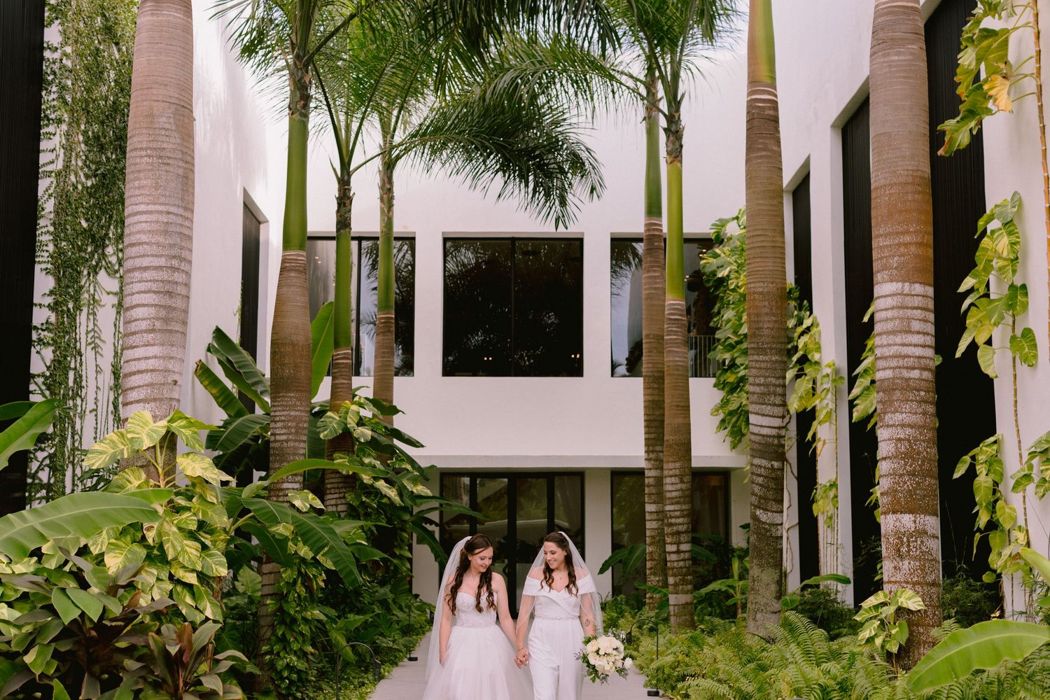 Two brides walking together at their Finest Punta Cana wedding