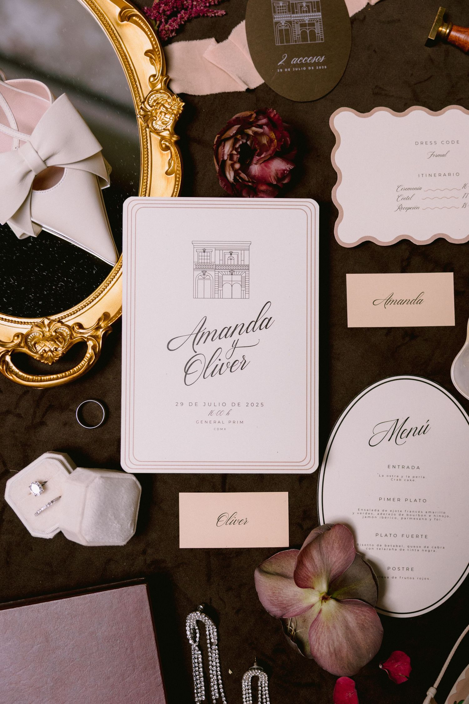 Elegant wedding invitations and stationery laid out with floral accents.
