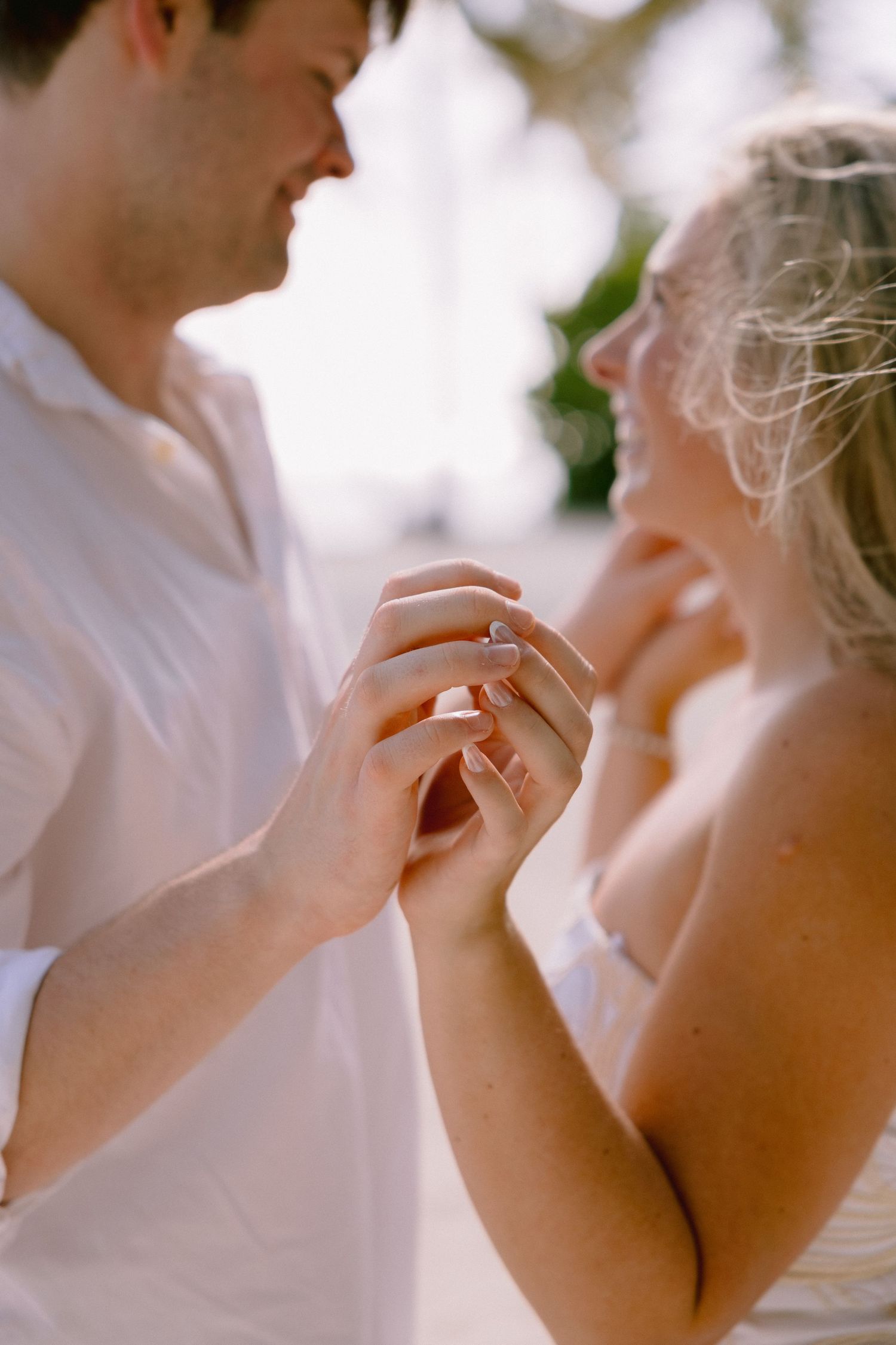 A close-up sequence showing hands exchanging a wedding ring during an intimate ceremony moment.
