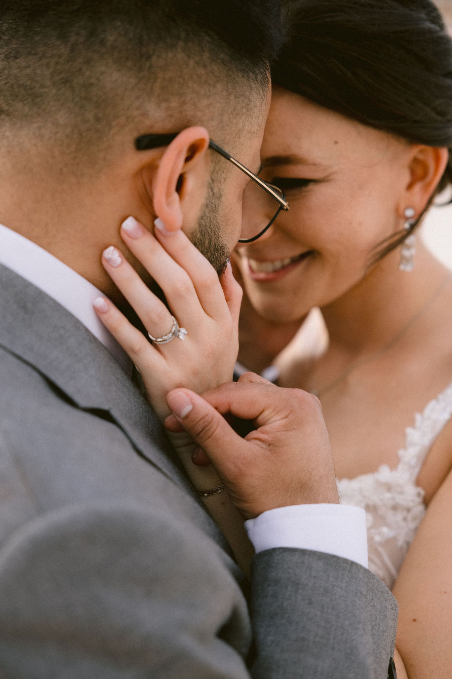 A romantic close-up series of a bride and groom sharing intimate moments in their wedding attire.