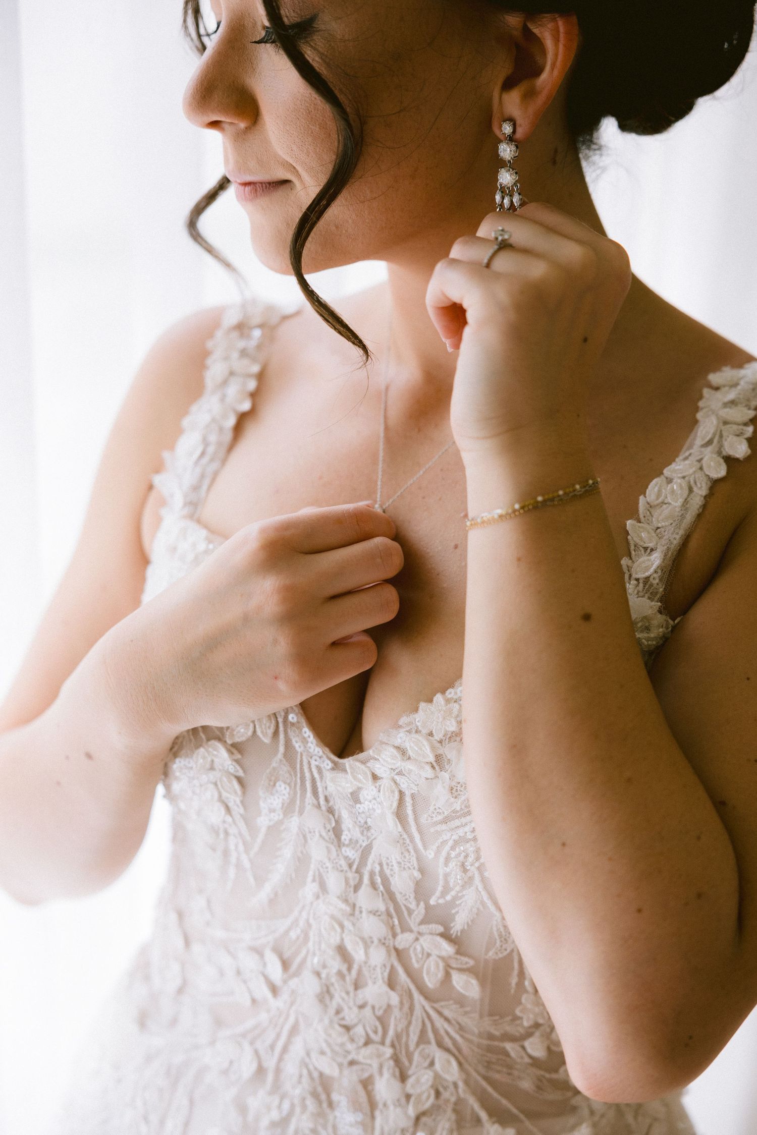 Close-up portrait series showing delicate lace details of a white wedding dress and elegant pearl jewelry.