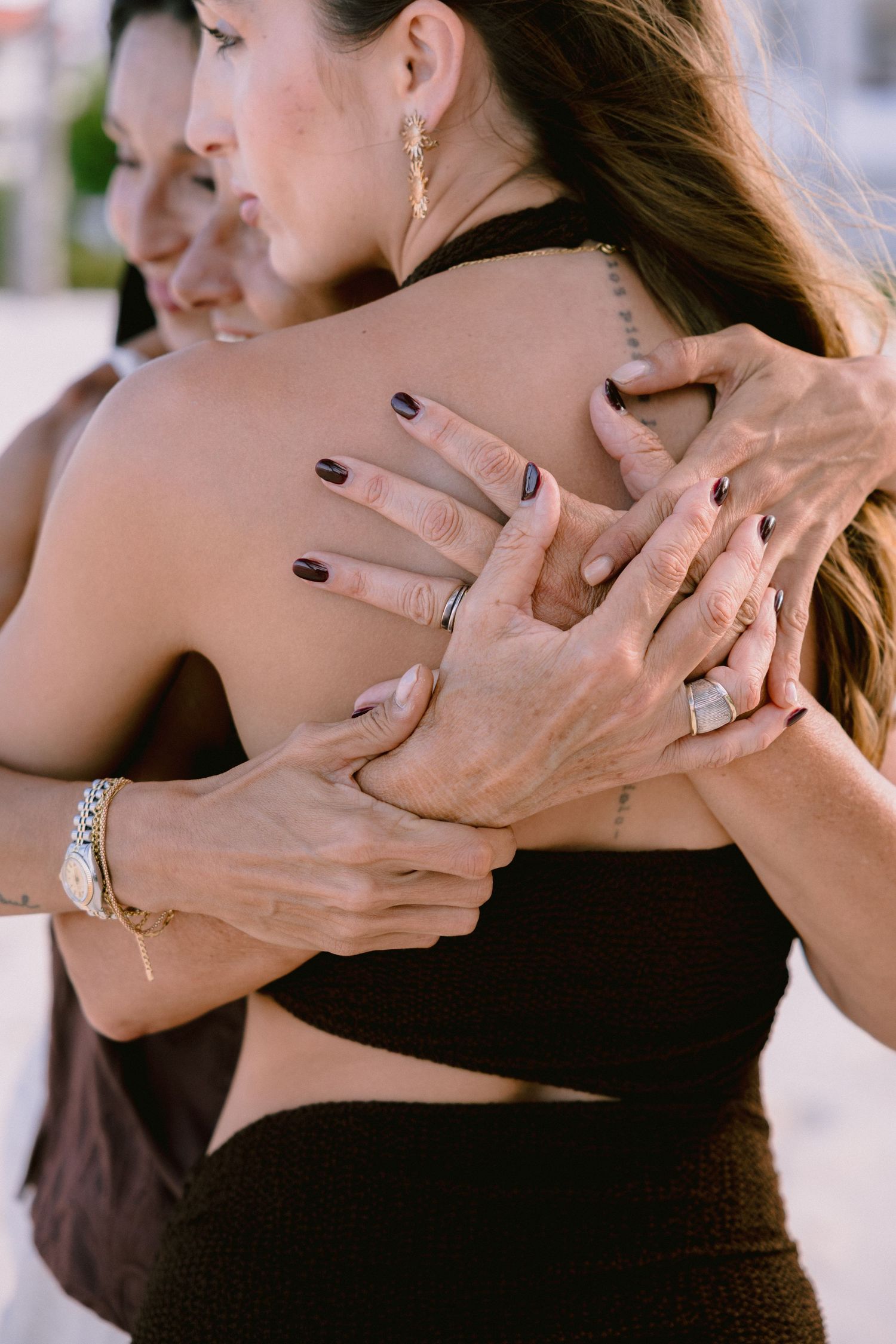 Close-up shot of hands tenderly touching and embracing.