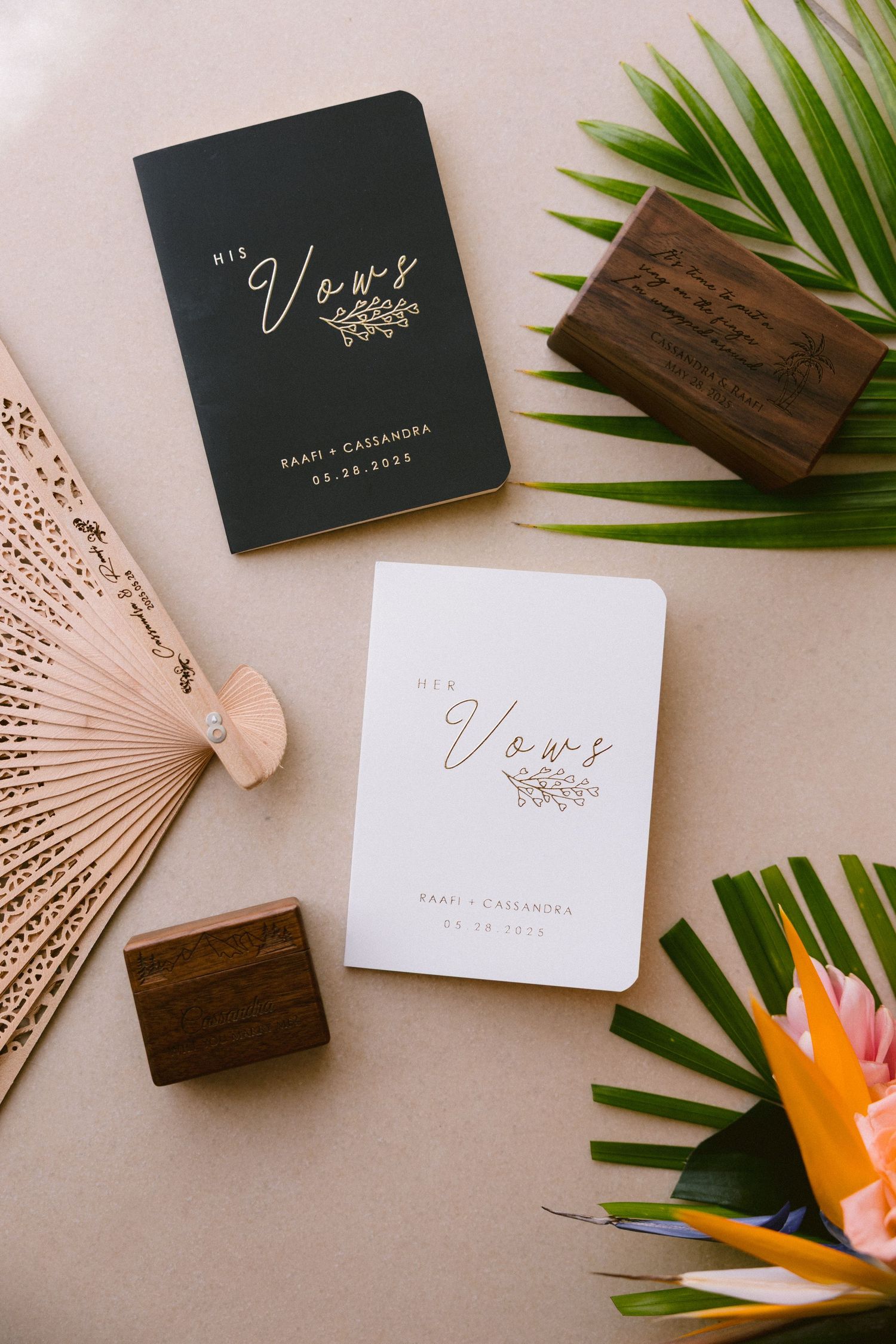 Elegant business cards with tropical elements like palm leaves, bird of paradise flowers, and wooden accents on beige background.