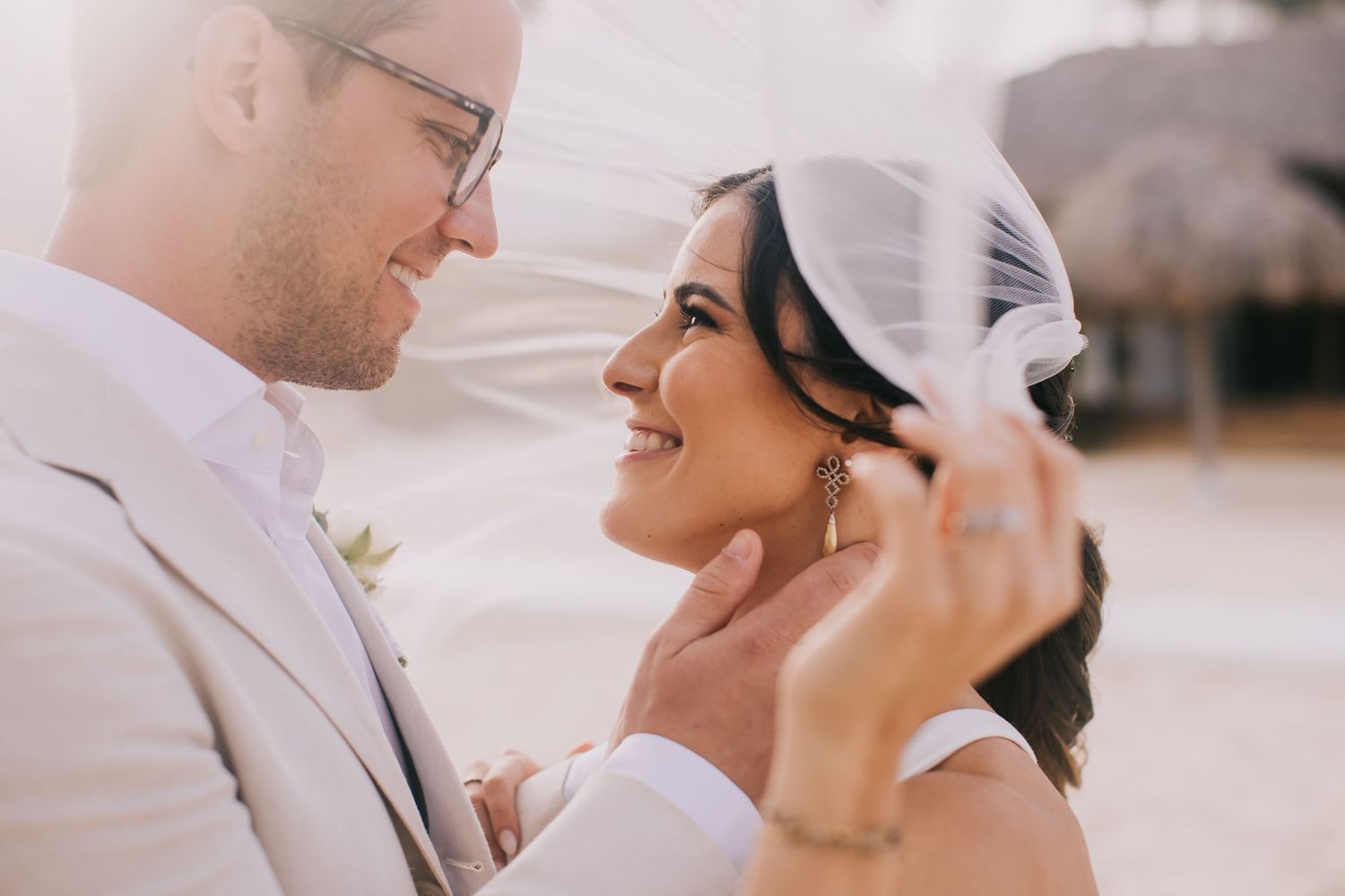 A romantic wedding moment captured between newlyweds on a beach.