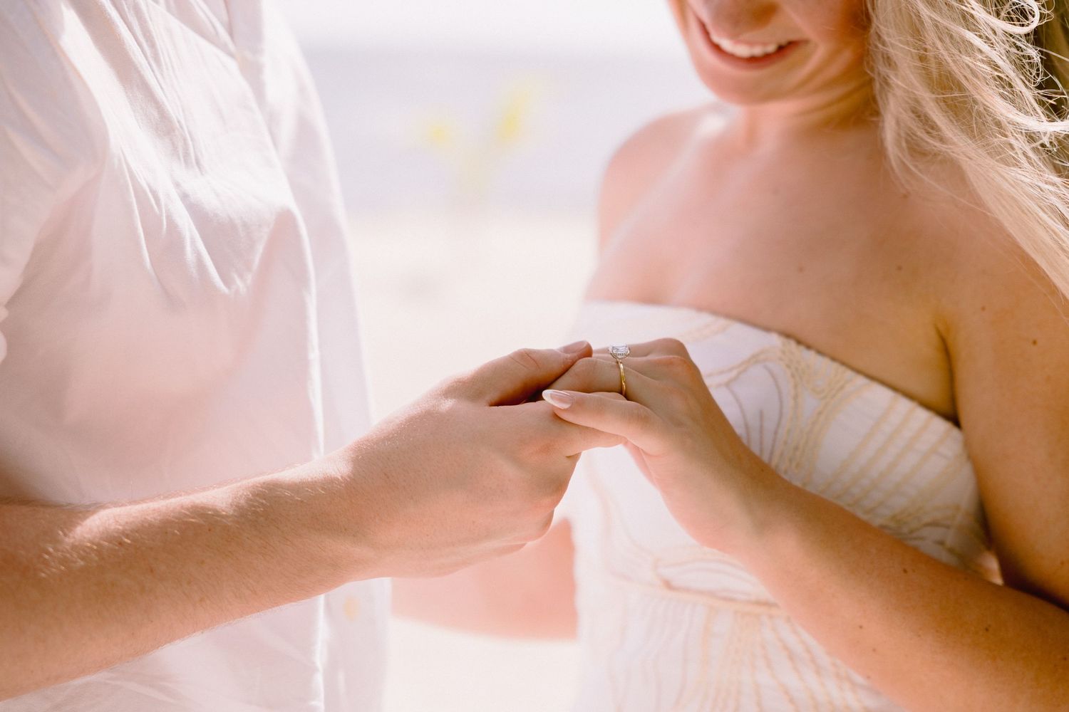A wedding couple shares a tender moment during their first dance in an elegant ballroom setting.