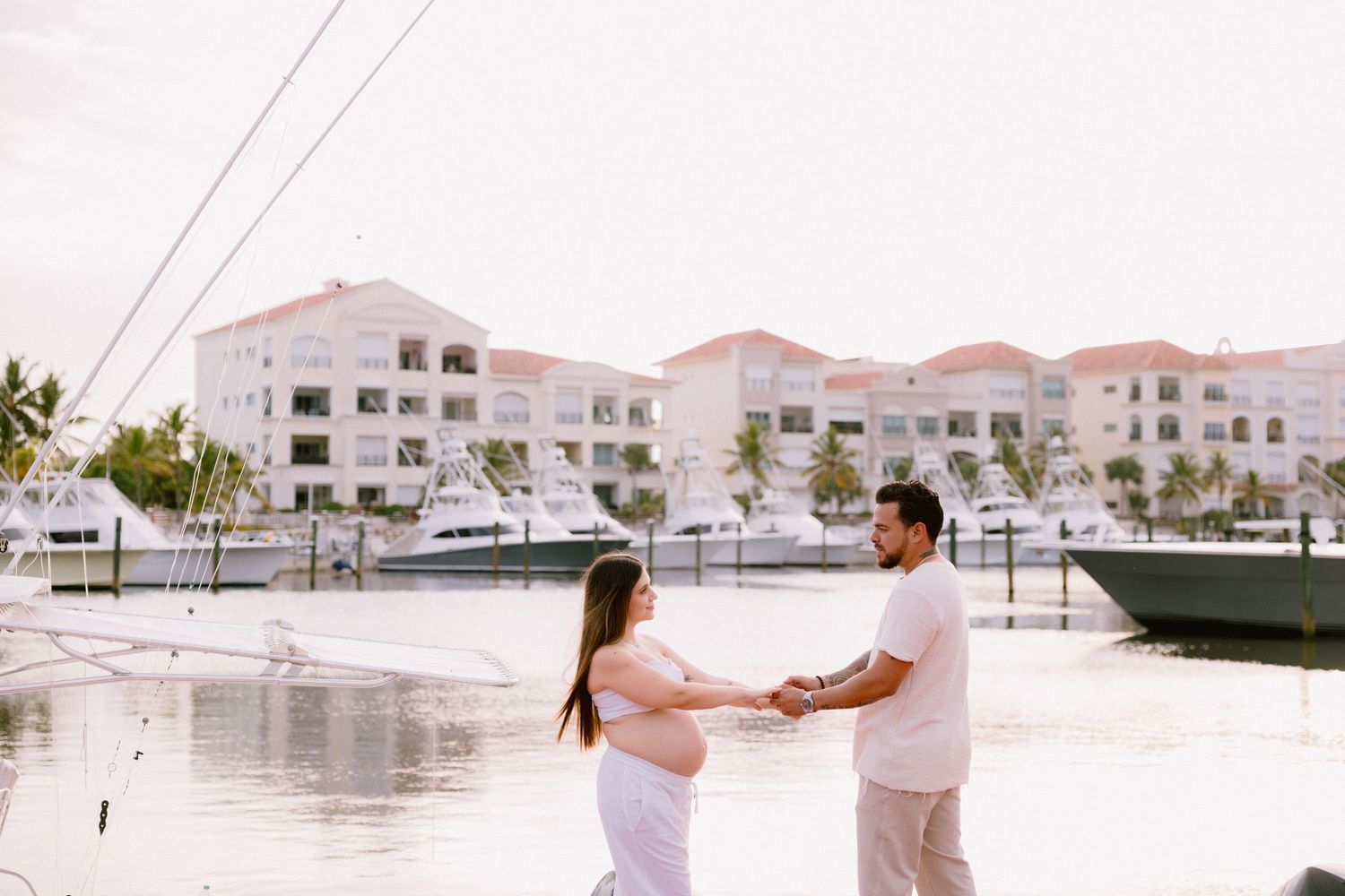 Romantic beachside photo shoot sequence of a couple walking and hugging along a scenic tropical resort coastline.
