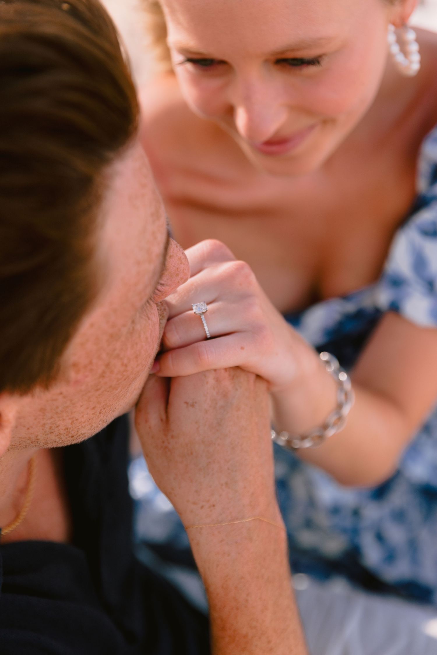 A series of close-up photos showing a ring being kissed in a romantic gesture during a special moment.