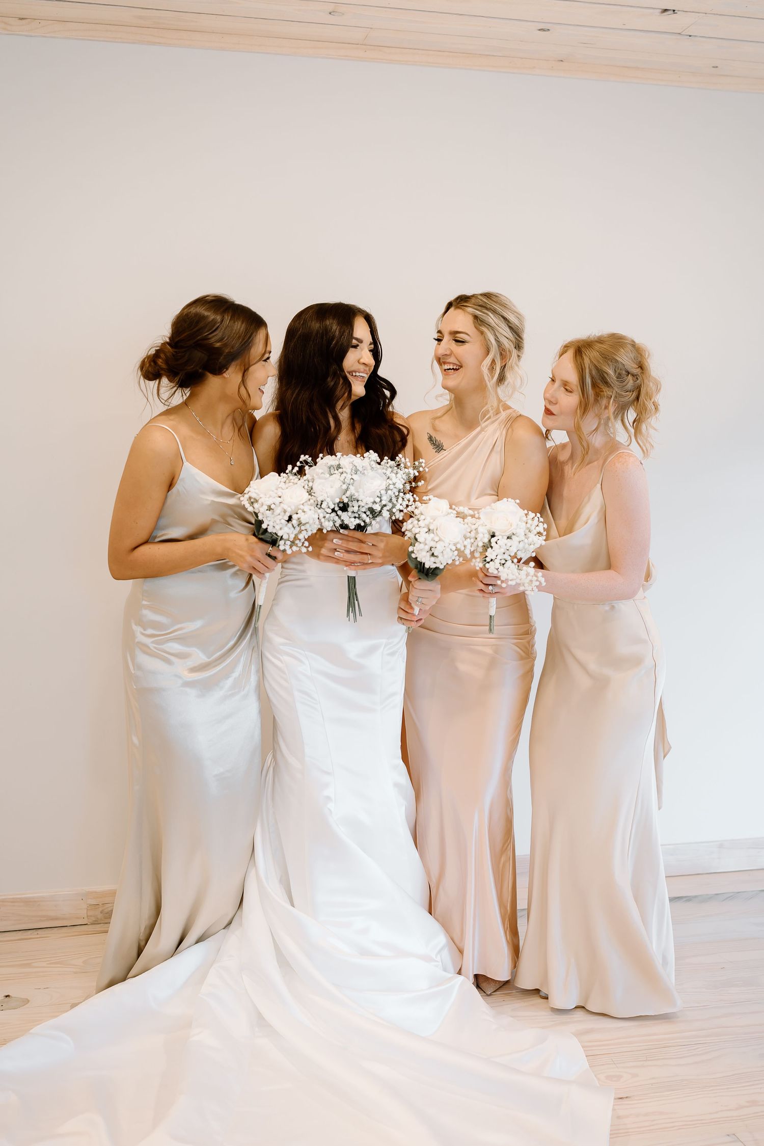 A wedding party in light colored dresses share an intimate moment in a sequence of candid photos.