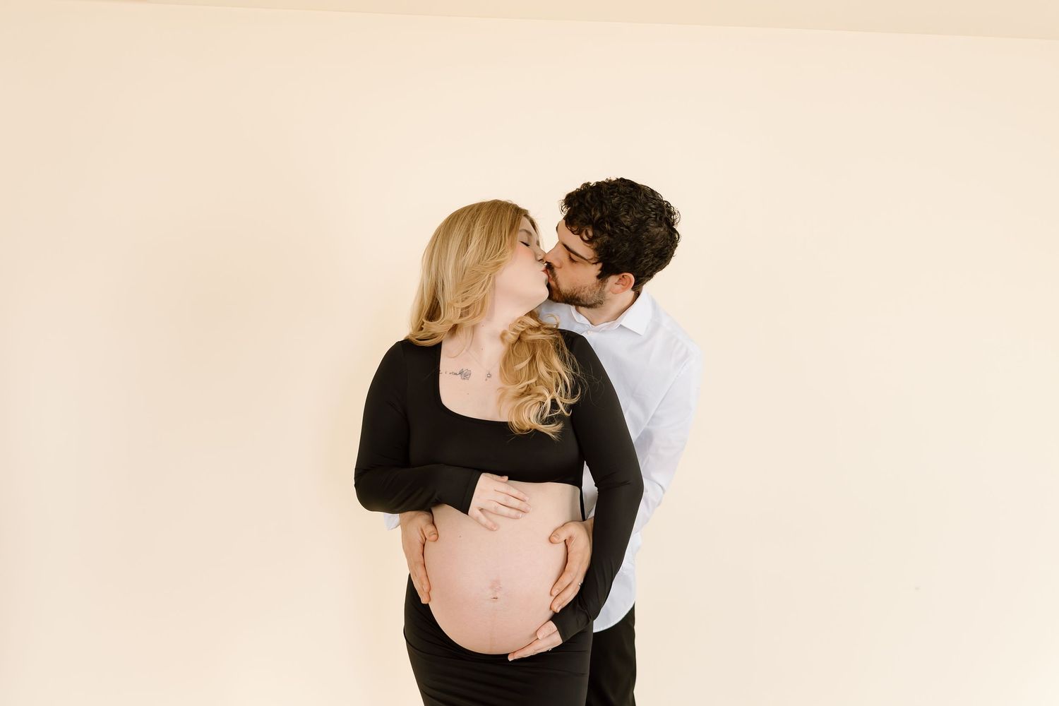 A romantic black and white photo series showing a couple embracing and kissing in tender moments.
