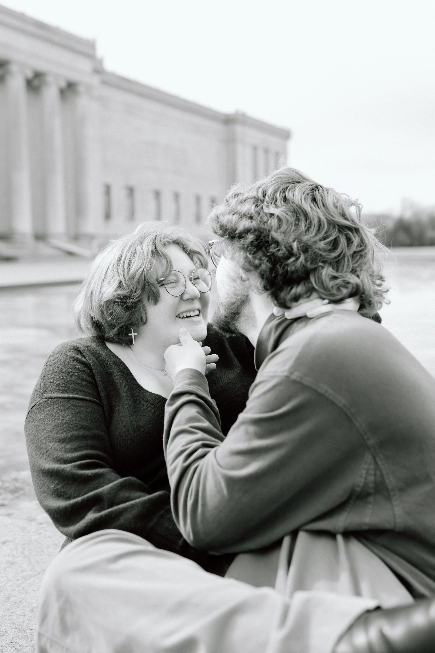 A sequence of four black and white photos showing a tender moment between two people embracing outdoors.