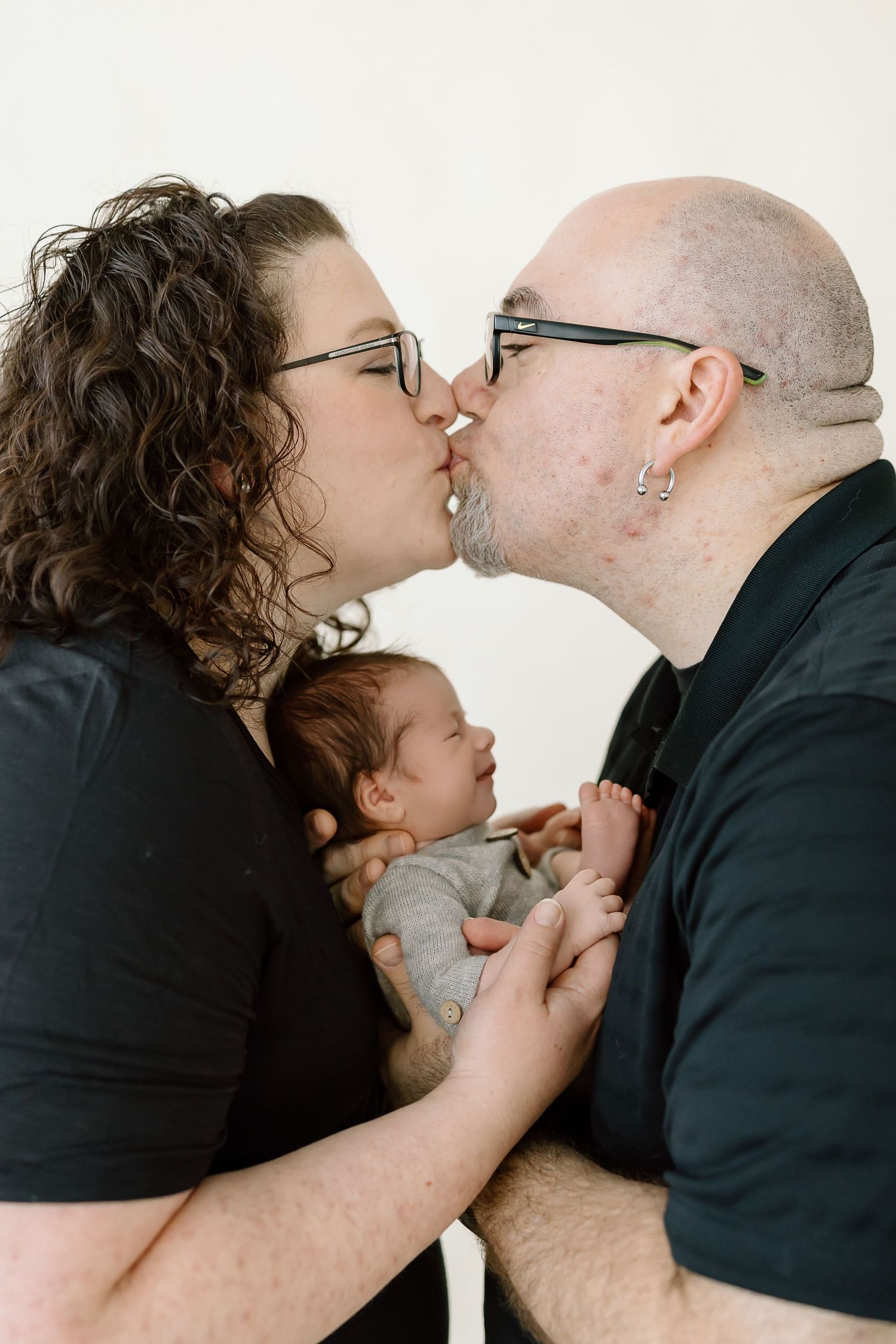 A sequence of five intimate black and white photos showing tender moments between a couple and child.