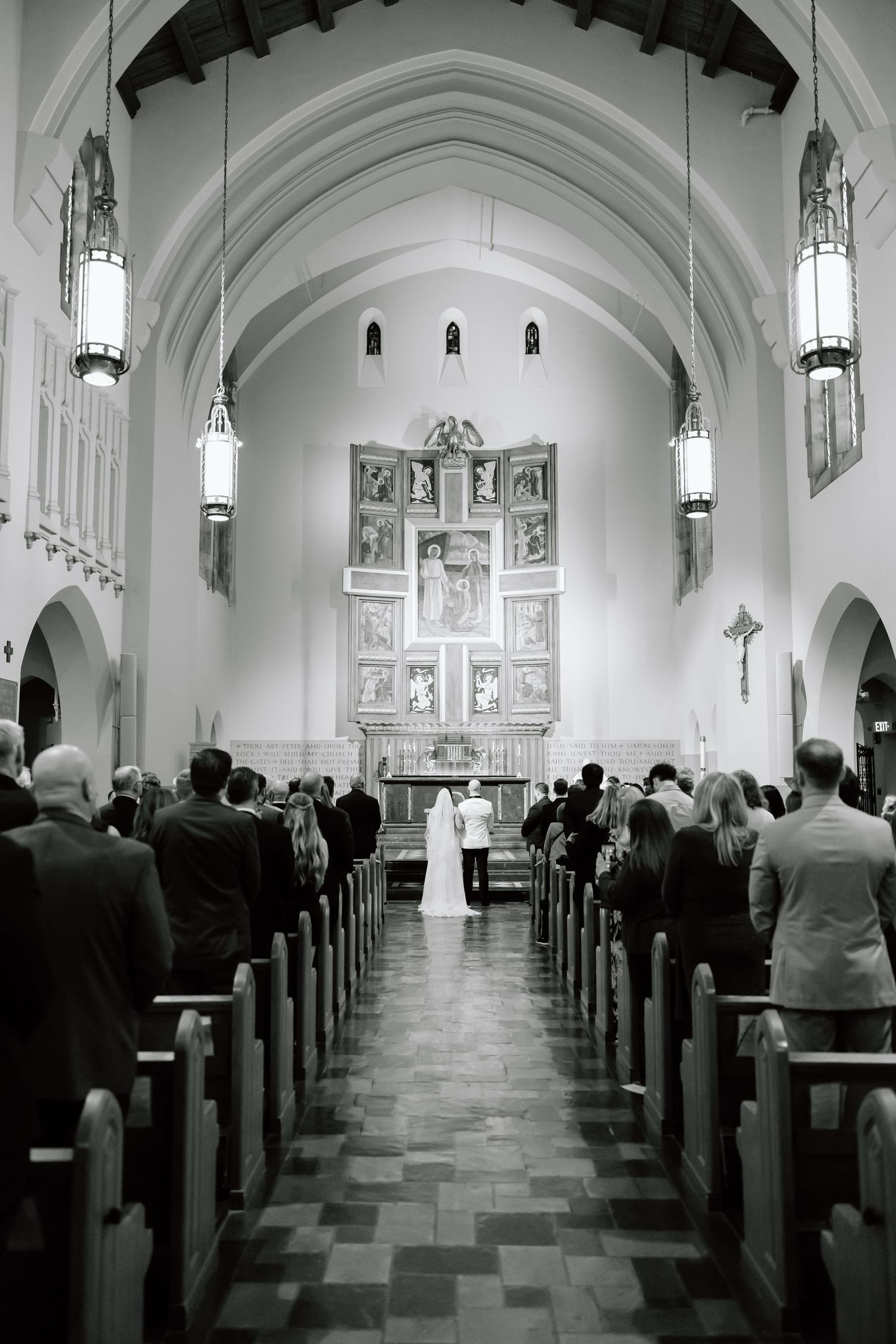 Black and white panoramic sequence showing the interior of a church during a wedding ceremony with guests seated in pews.