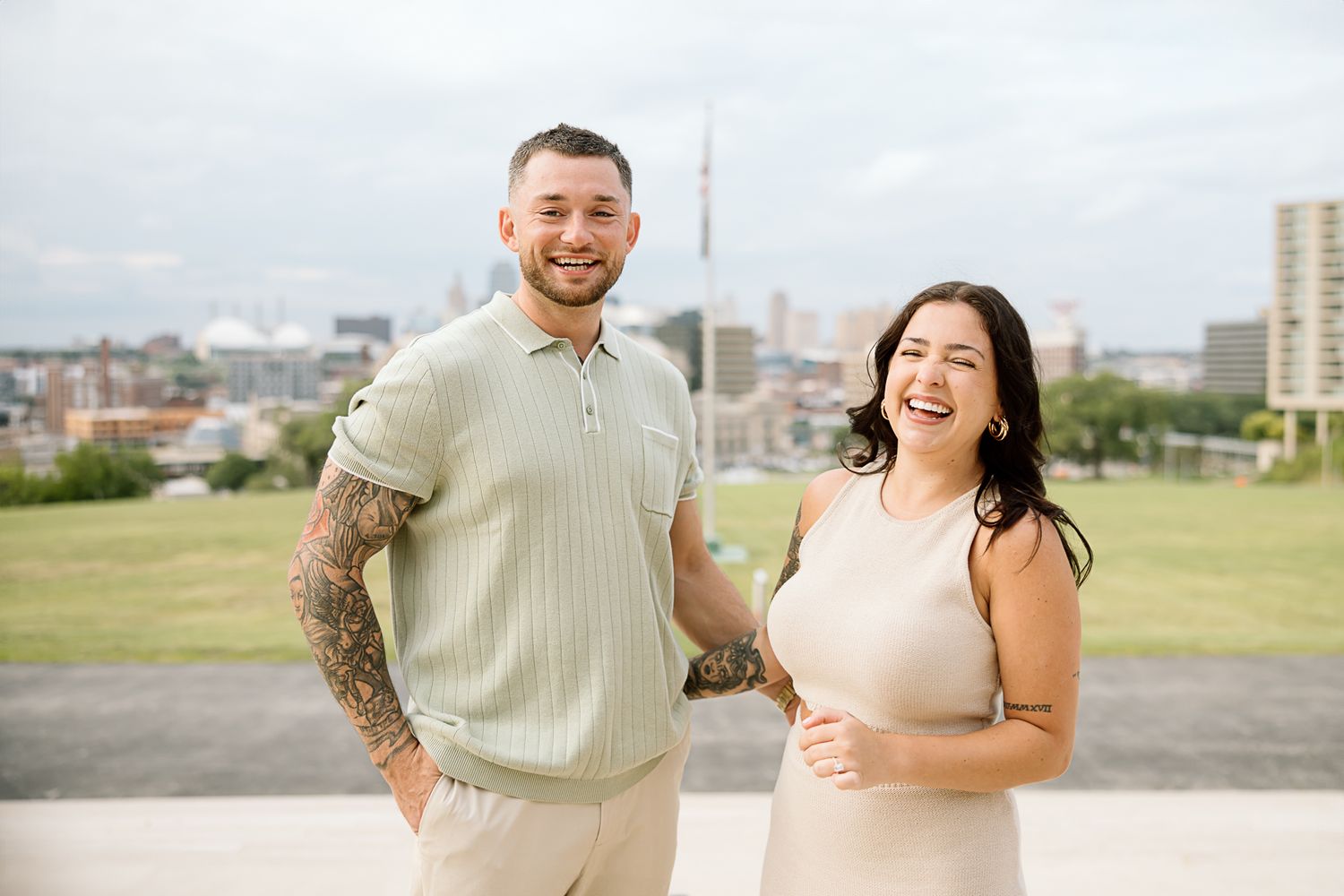 A couple shares a tender moment during their engagement session in an urban setting.