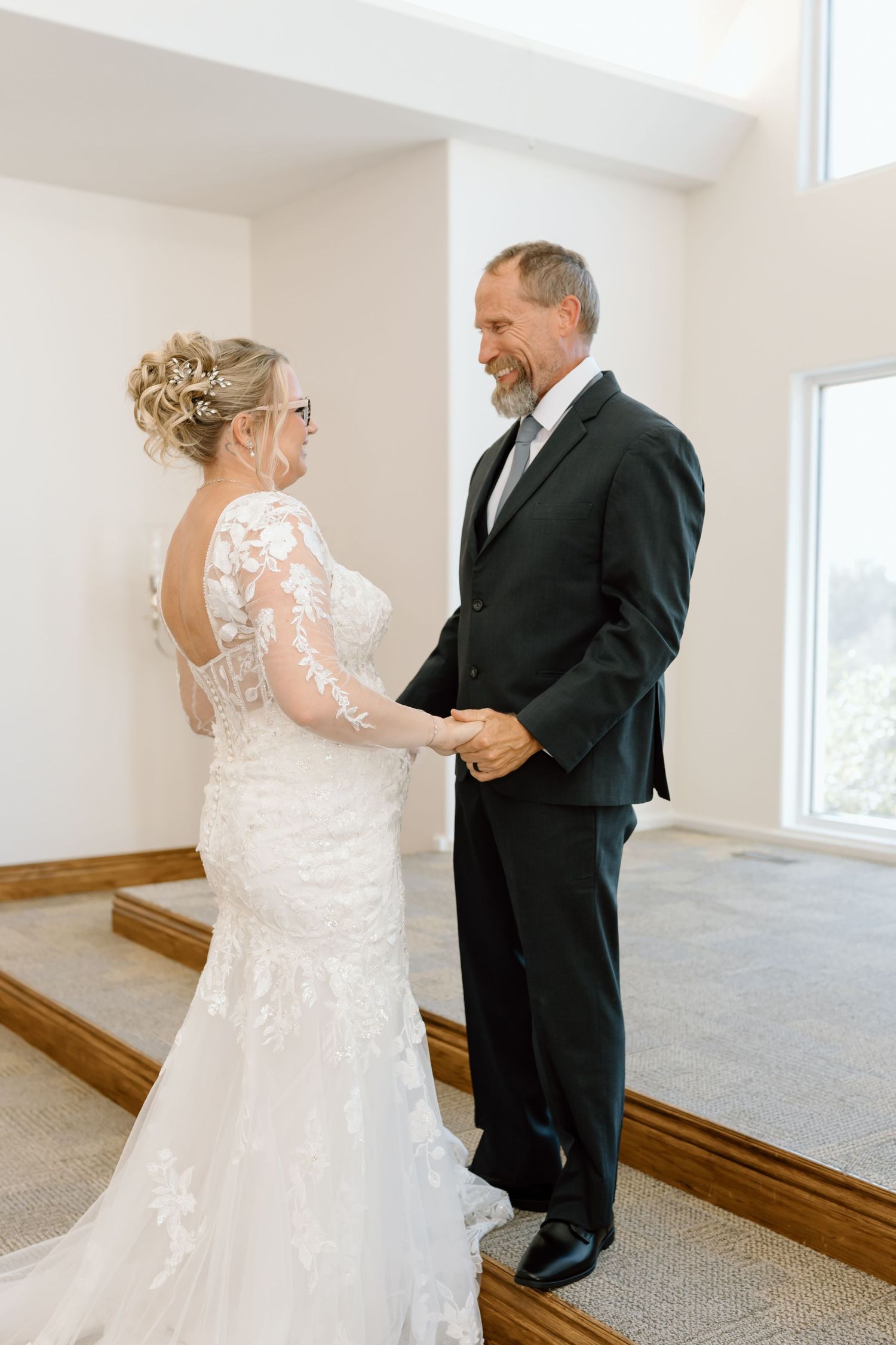 A first look wedding moment captured in sequence as the couple shares an emotional reaction in a bright indoor setting.