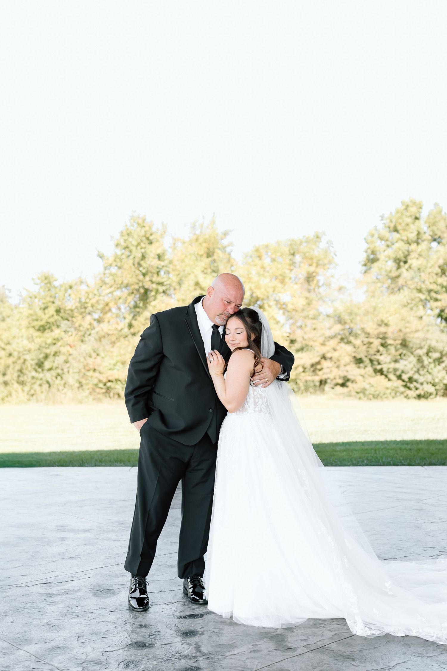 A romantic wedding couple shares a tender kiss in a sequence of photos on a bright outdoor patio.