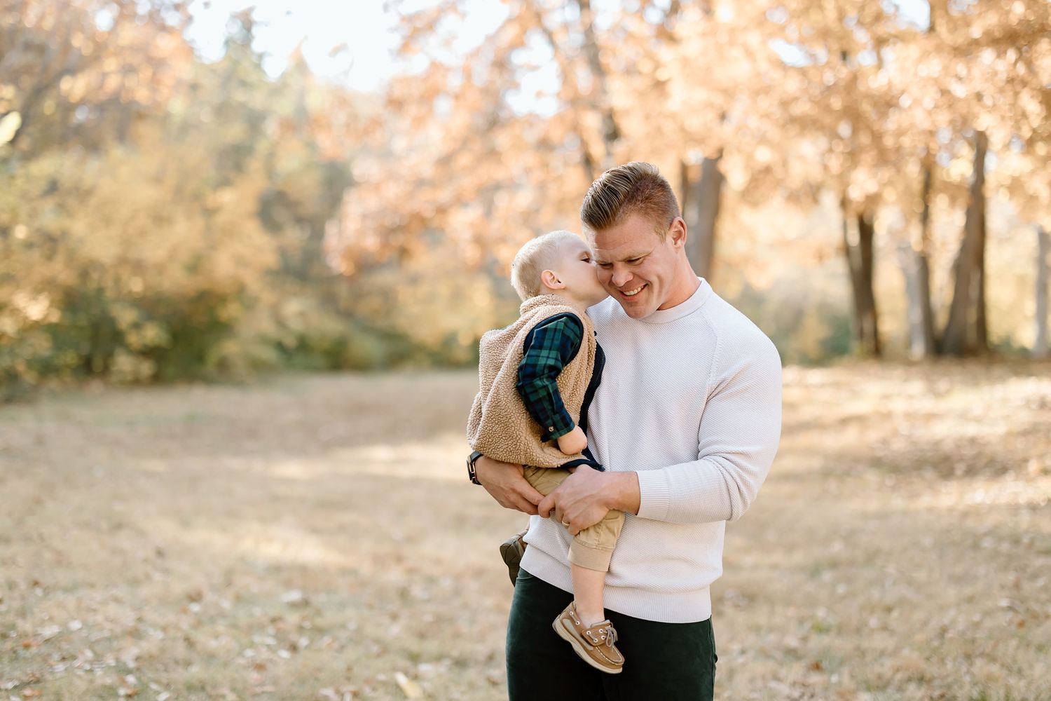 Candid outdoor family portrait with warm autumn colors and natural lighting.