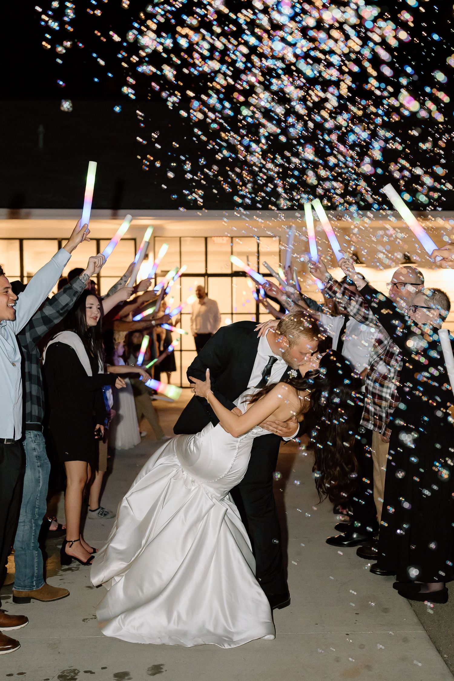 A sequence of photos showing a couple dipping and dancing at their wedding reception with confetti falling around them.
