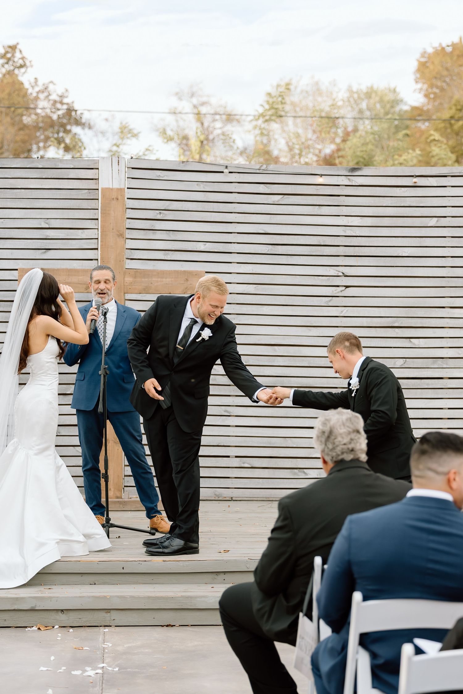 A series of wedding photos showing a playful moment on outdoor wooden bleachers during a ceremony.