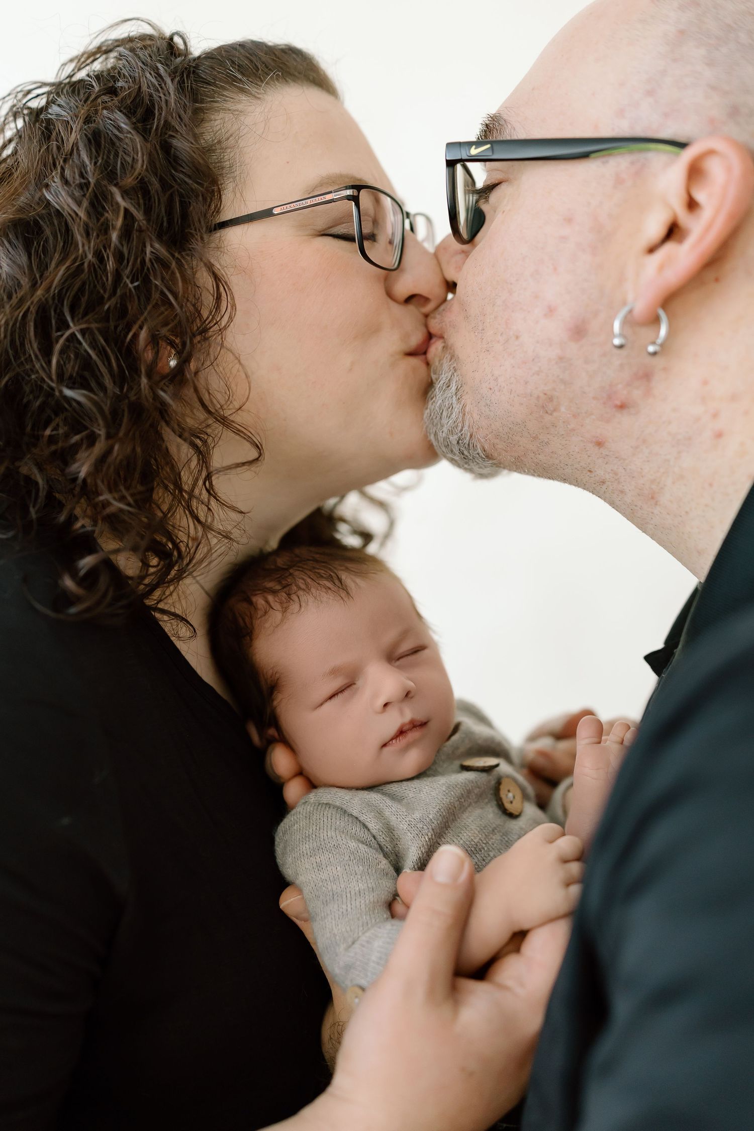 A tender series of close-up shots showing a parent sharing gentle kisses and affection with their sleeping baby.