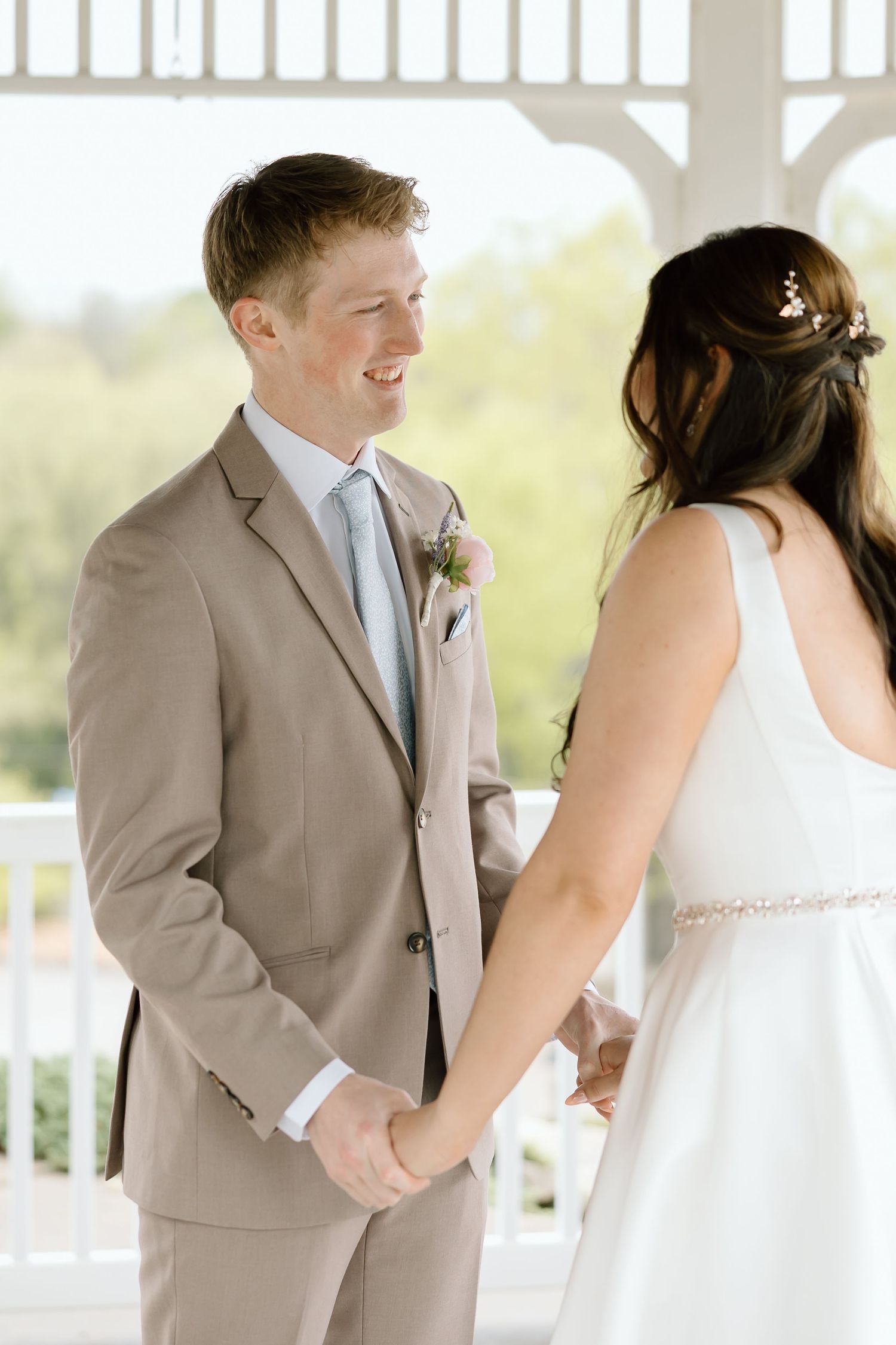 A series of wedding photos showing the first look between bride and groom in a light and airy outdoor setting.