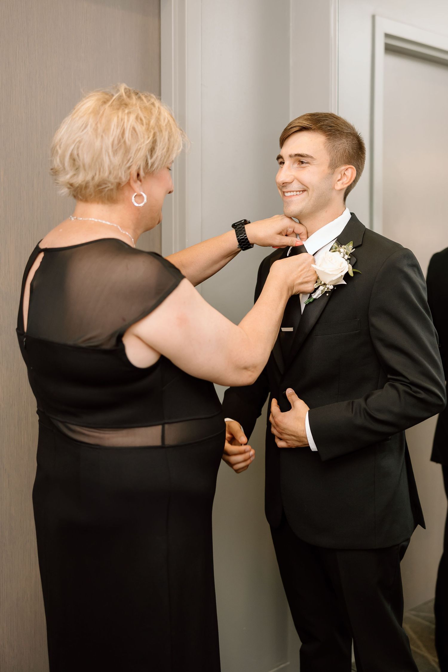 A sequence of images shows two people in formal wear playfully interacting near a wall.