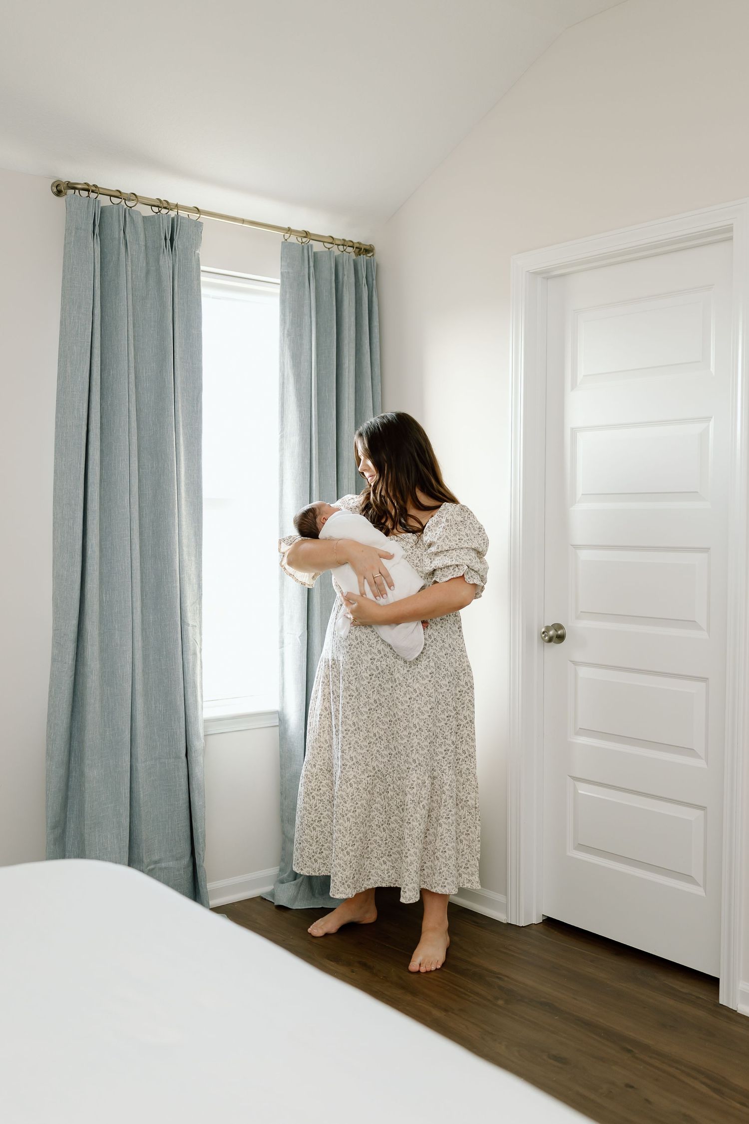 A sequence of images showing someone checking behind curtains and doors in a bright white room with wood floors.