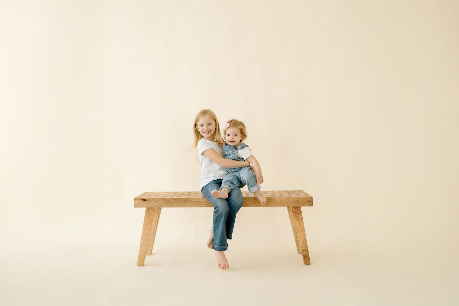 A sequence of photos showing a child in denim climbing and playing on a wooden bench against a cream background.