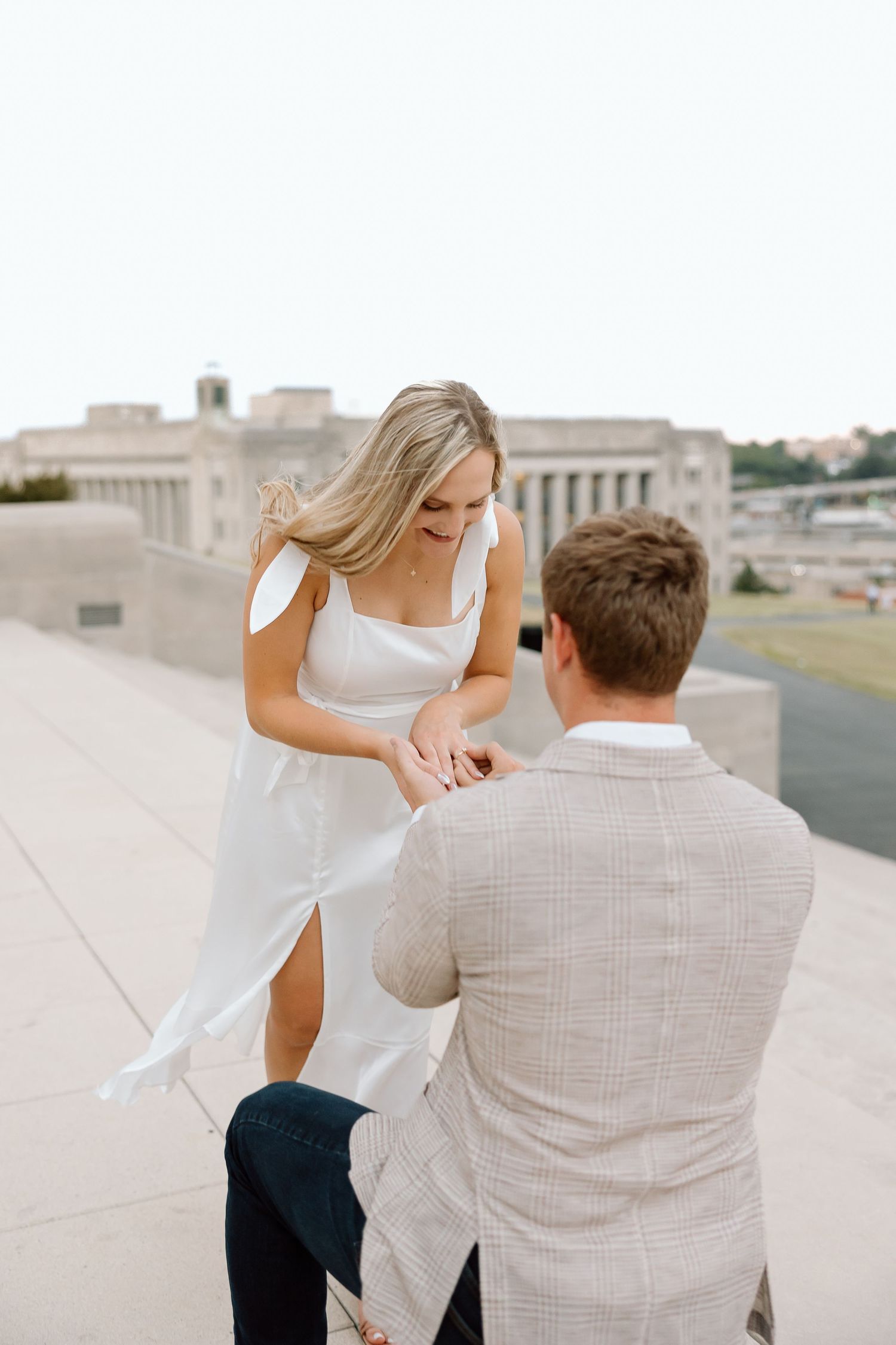 A couple shares a romantic moment in a series of three connected photos showing them dancing on a rooftop.