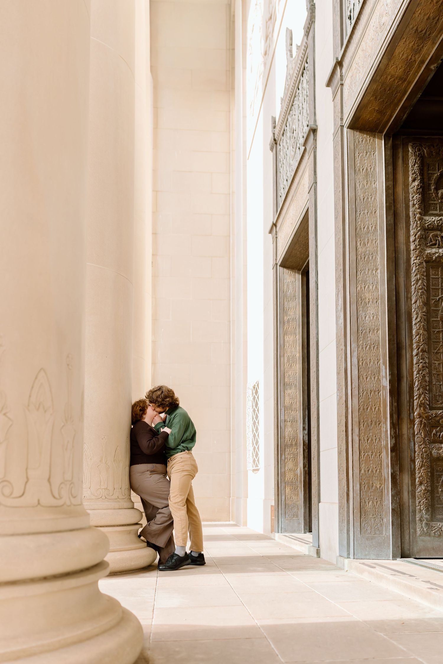 Four sequential photos showing a small child crouching and peeking behind white architectural columns in a bright space.