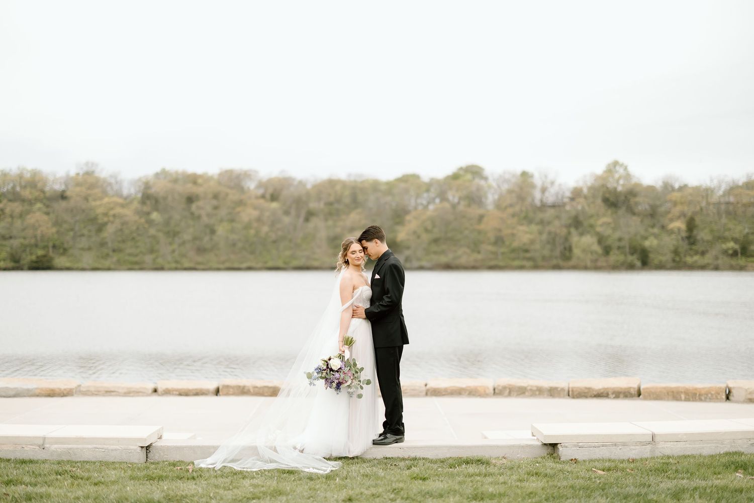 Couple shares intimate moment during waterfront wedding photo session.