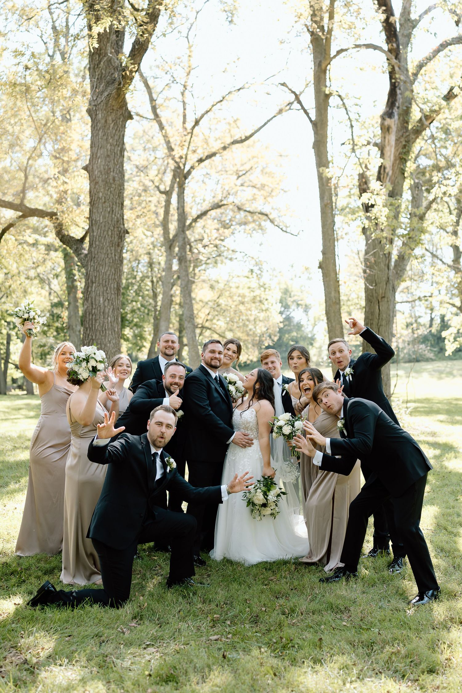 Wedding party poses playfully in sequence of four candid shots under autumn trees in a park setting.