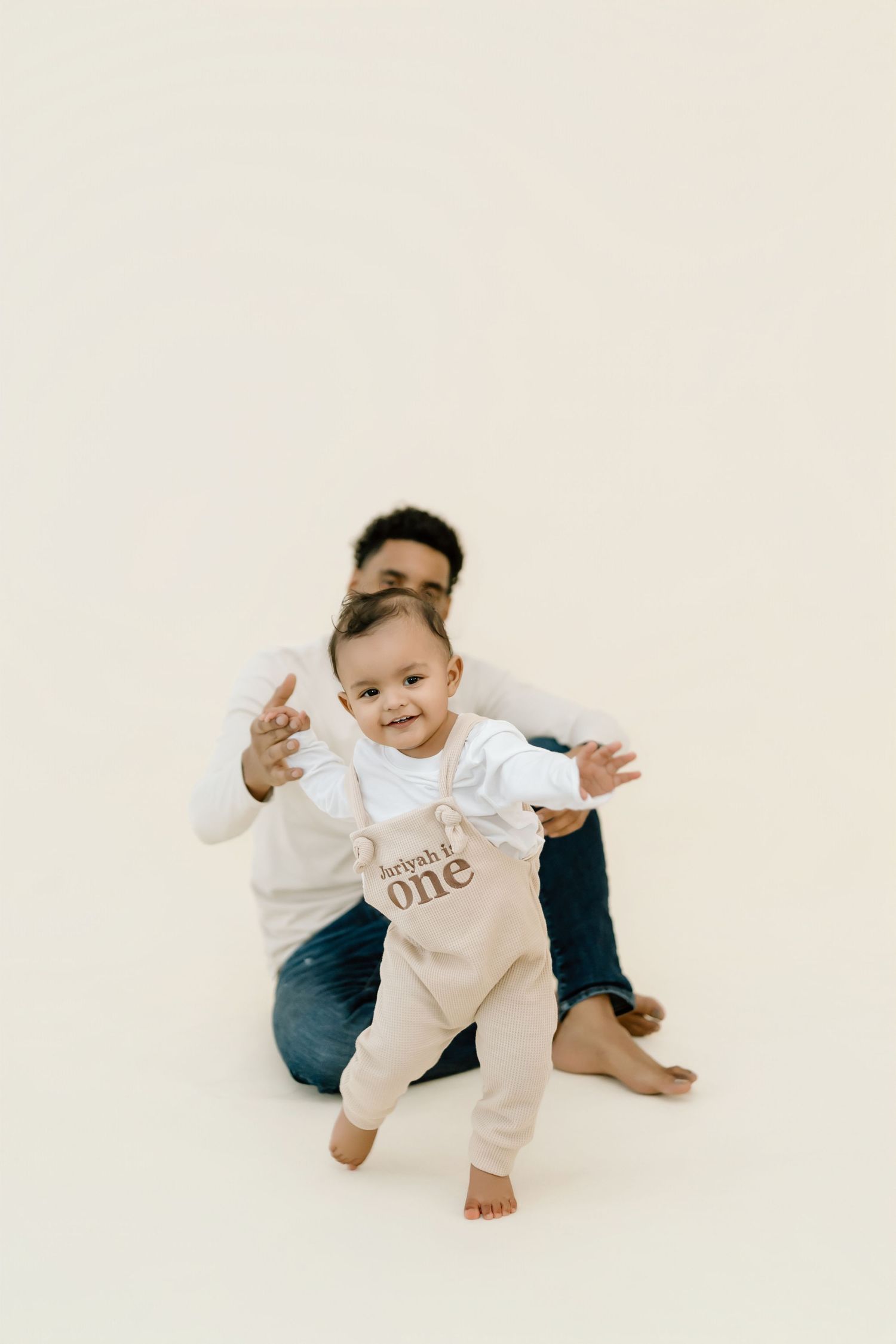 A baby in a white onesie with 