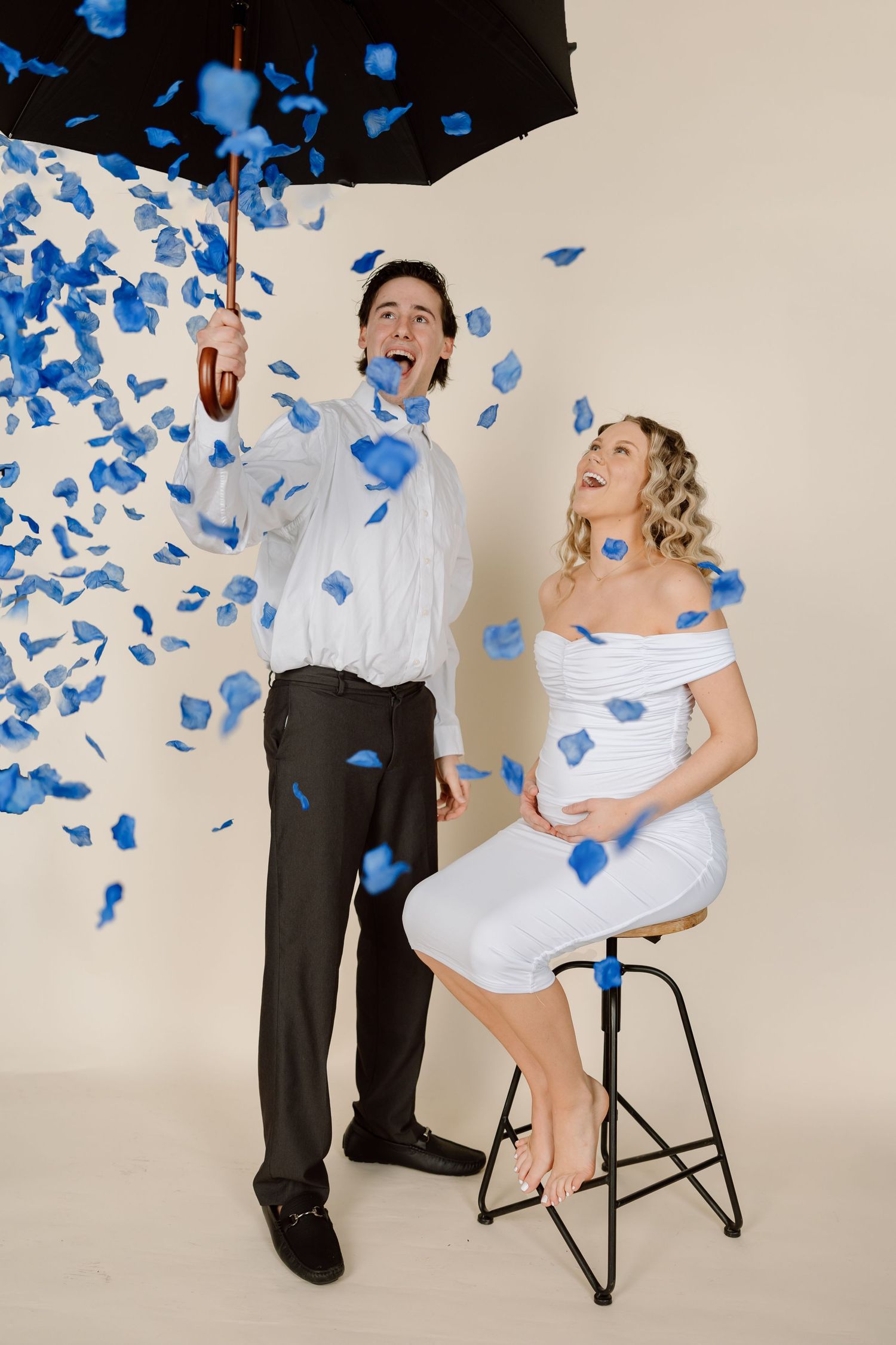 A series of photos showing a couple celebrating with blue confetti during a gender reveal announcement.