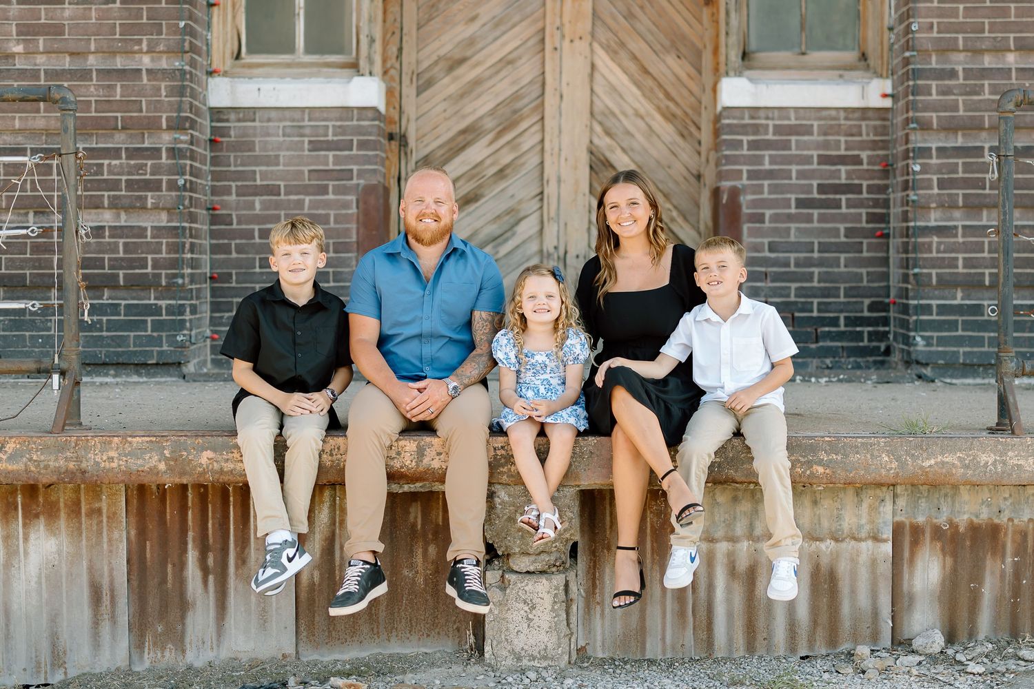 Four casual family photos arranged in a row against a rustic brick wall backdrop.