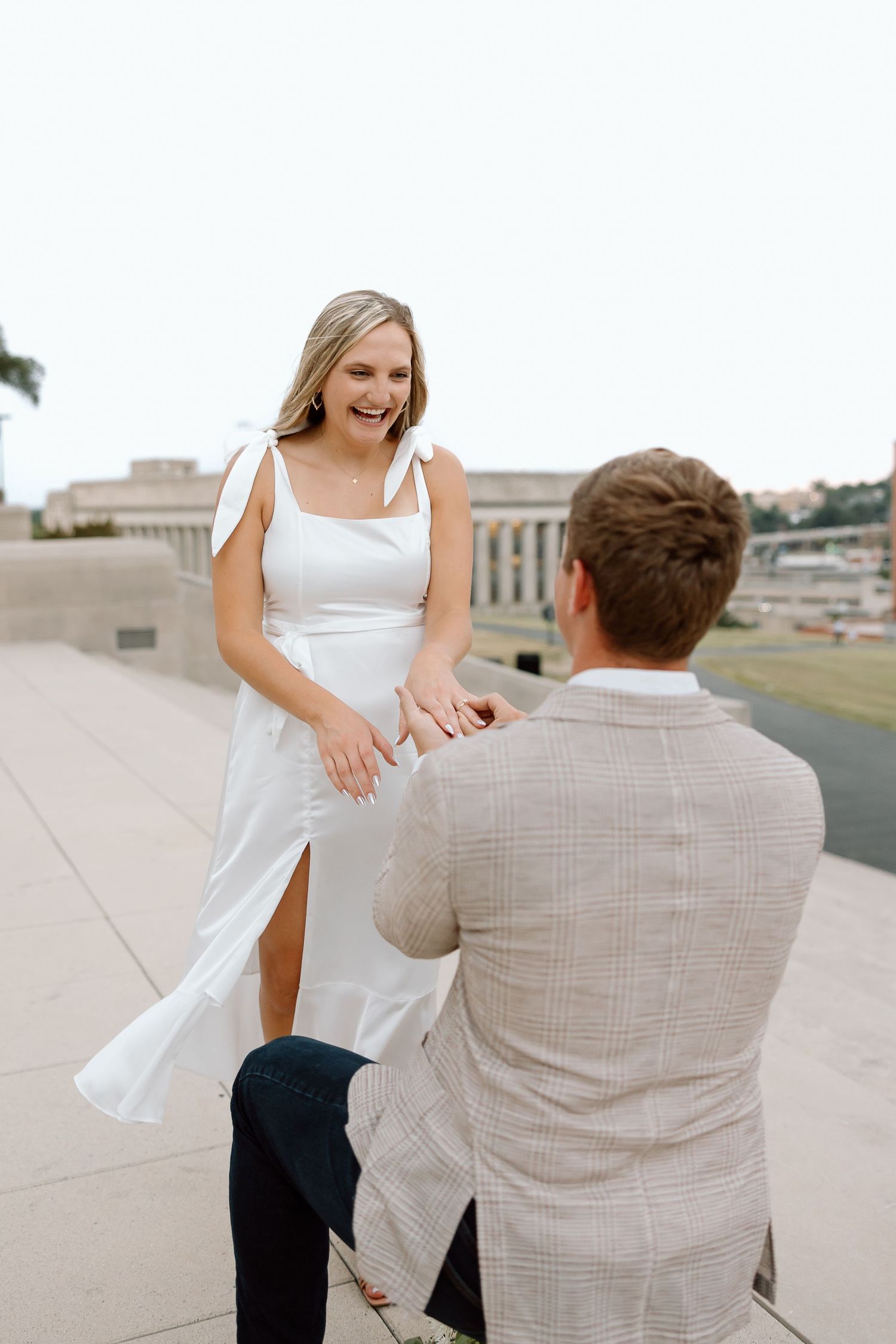 A romantic engagement photo sequence showing a proposal moment on a rooftop terrace.