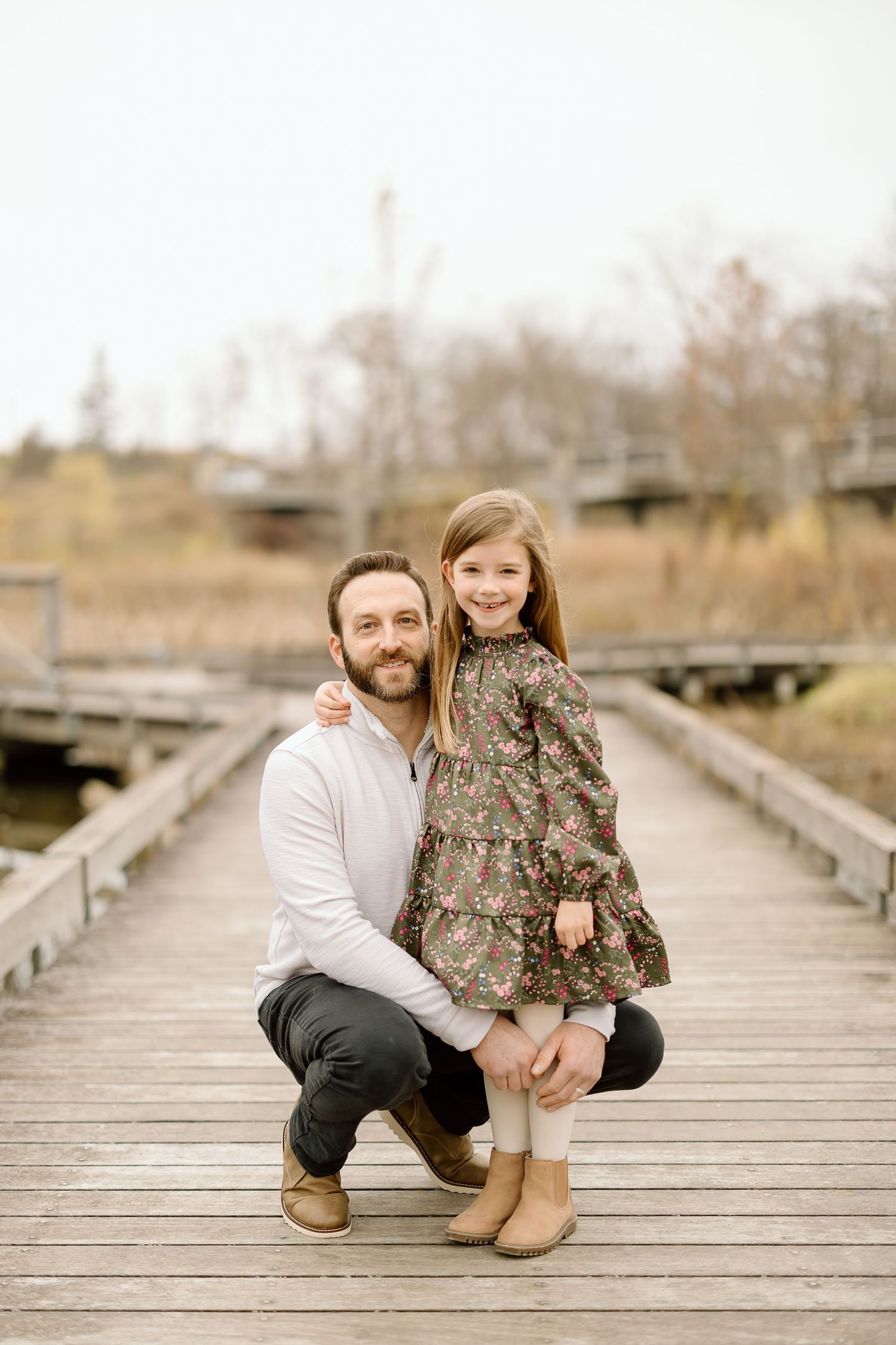 A heartwarming moment between parent and child on a wooden boardwalk.
