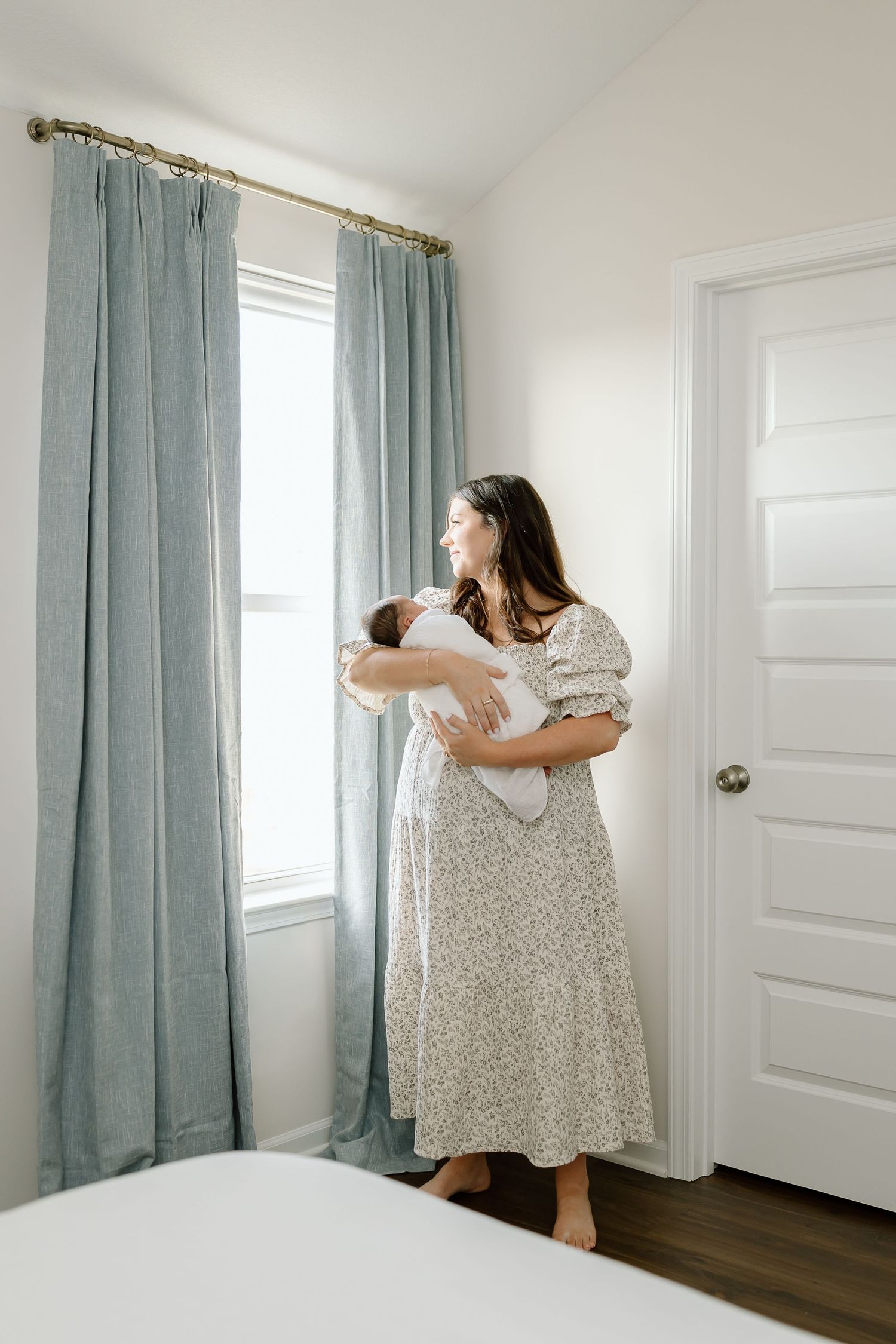 Four sequential photos show someone opening blue curtains in a bright white bedroom to let natural light in.