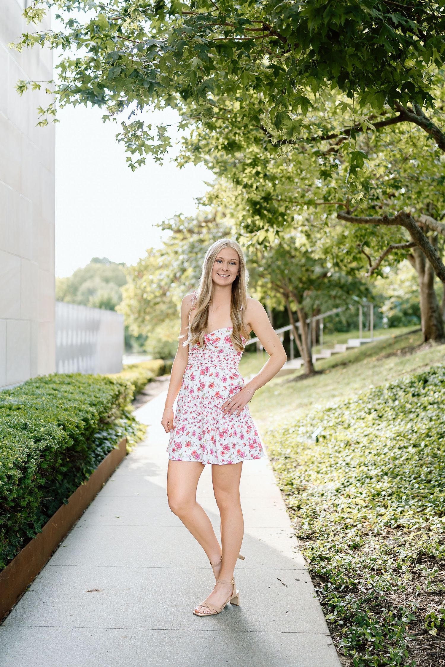A series of outdoor portraits on a sunny day with greenery and a concrete path in the background.