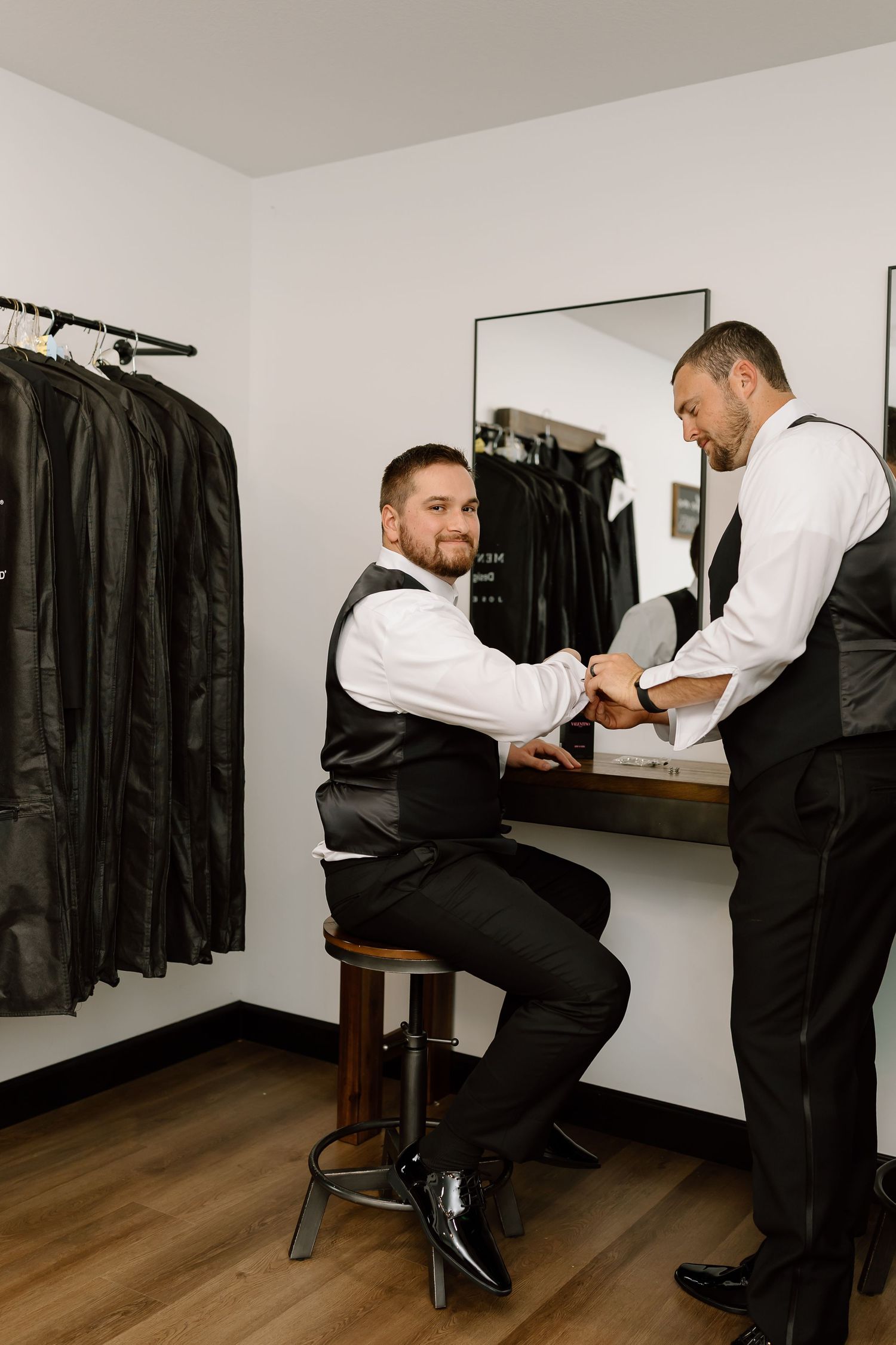 A sequence of photos showing someone getting their shoes shined by a professional shoe shiner at a formal shoe shine station.