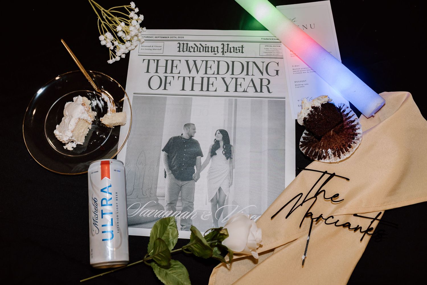 A collage of wedding-related items including magazines, decor, and floral arrangements on a light surface.