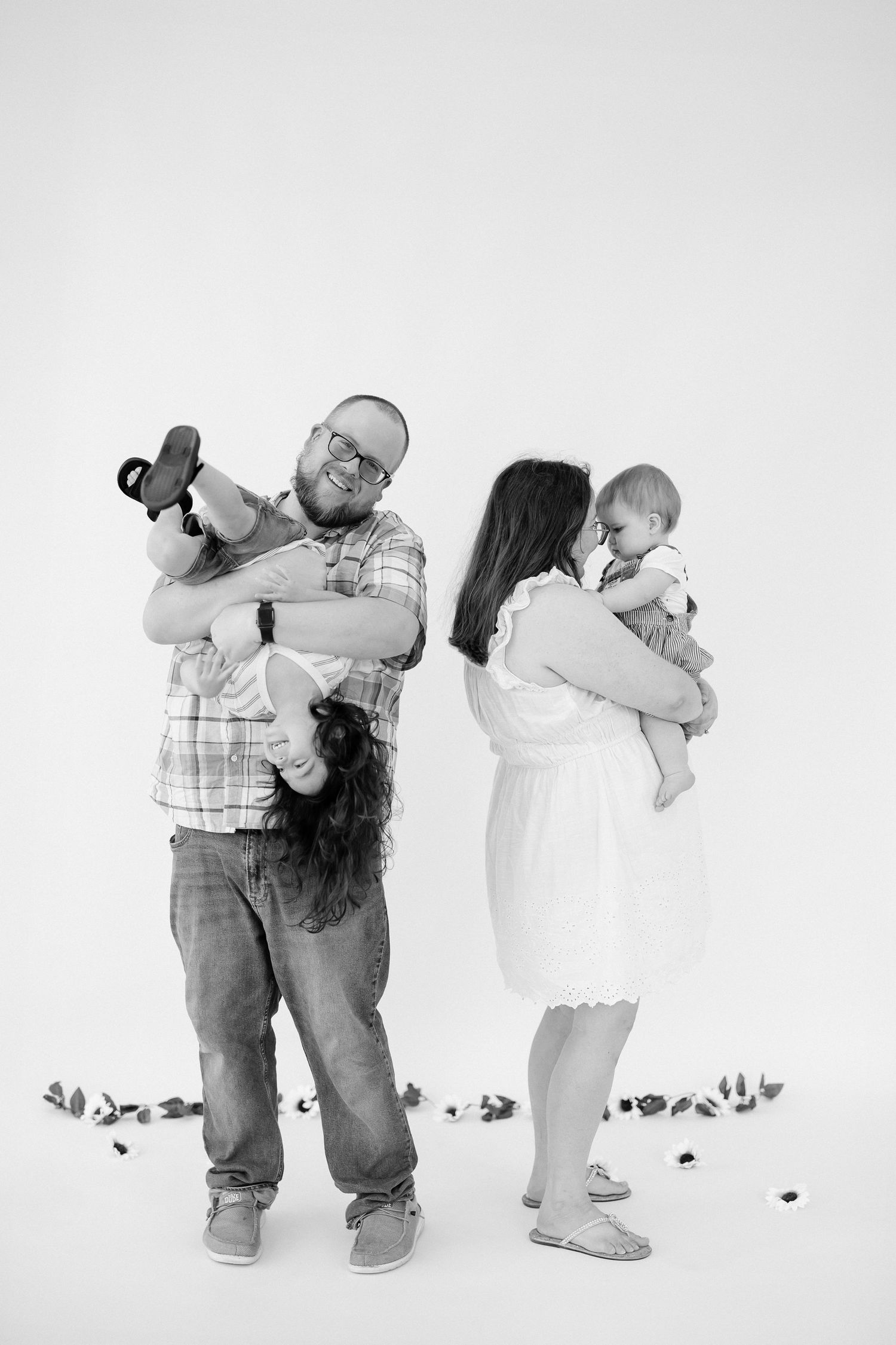 A series of black and white photos showing a couple dancing and embracing in casual attire.