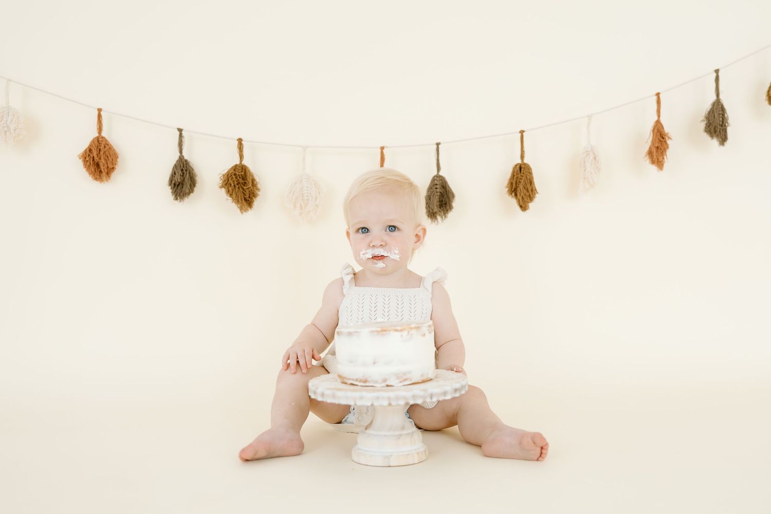 A series of four connected photos showing a white birthday cake with candles and decorative elements.