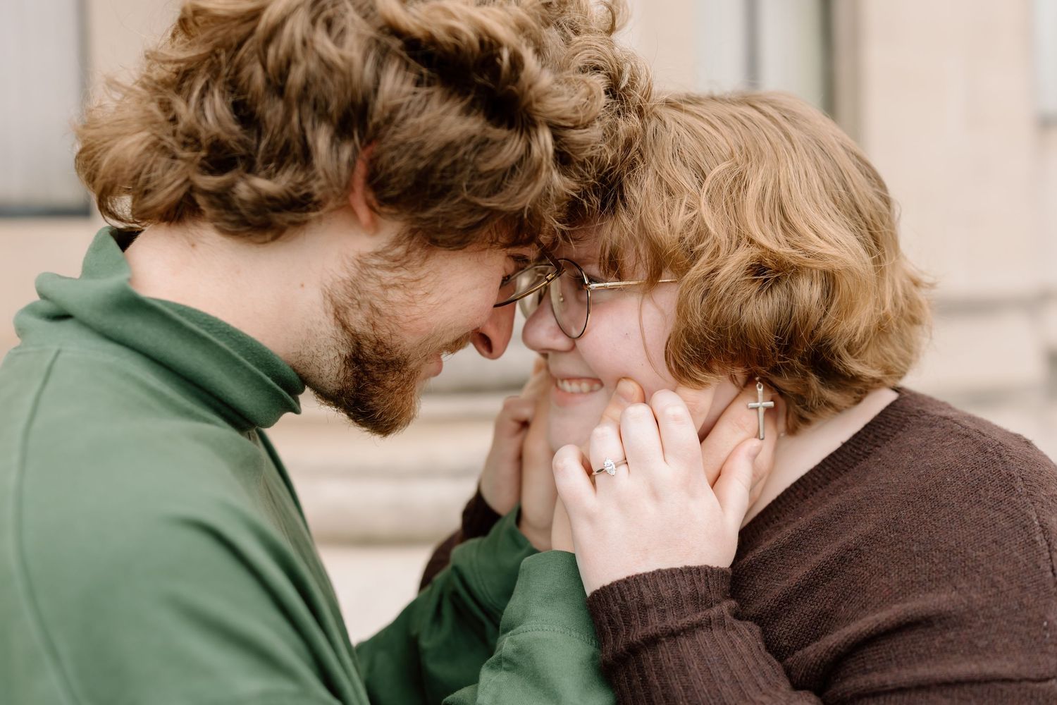 A couple in green and brown sweaters share an intimate moment together in a series of candid photos.
